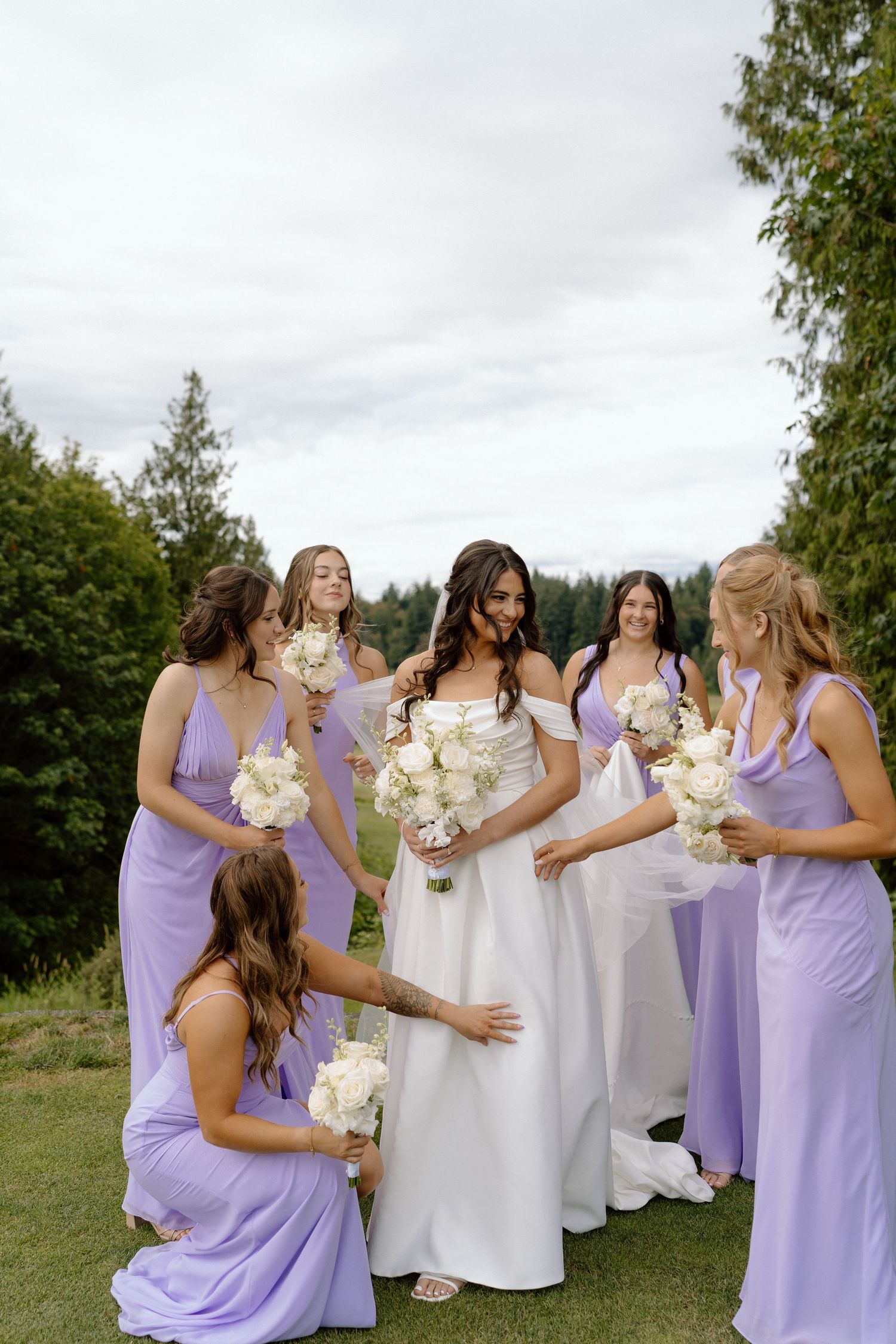 bridesmaids helping the bride