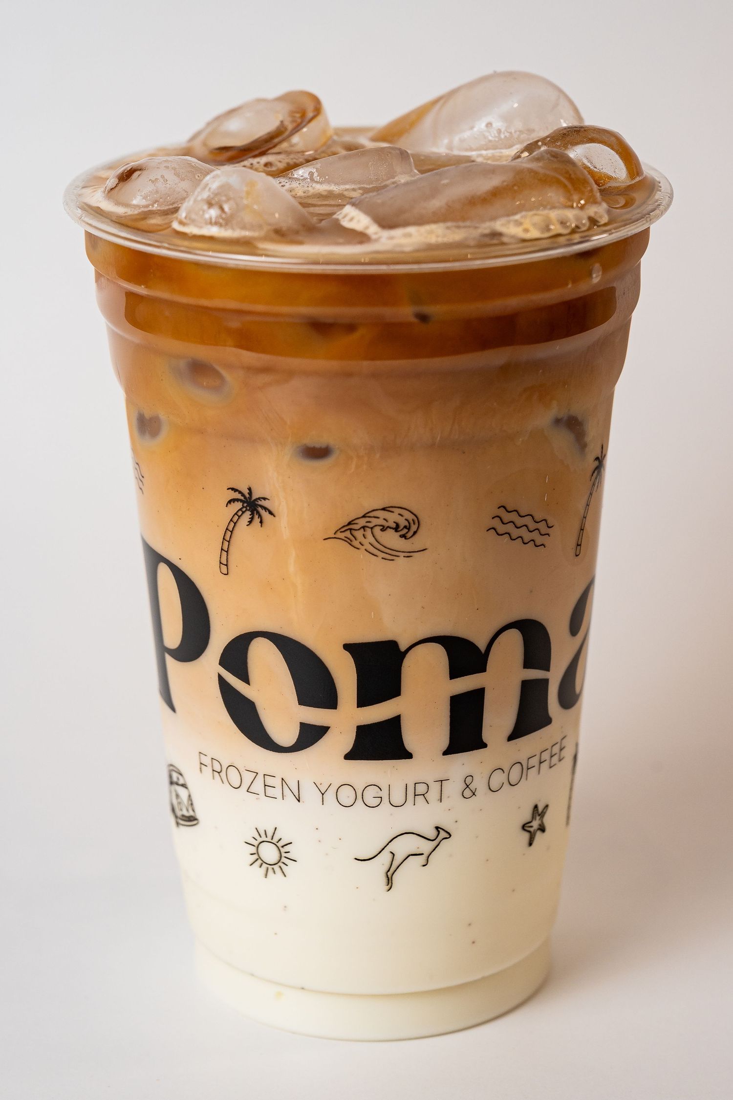 Poma Frozen Yogurt & Coffee iced latte in branded plastic cup on white background.