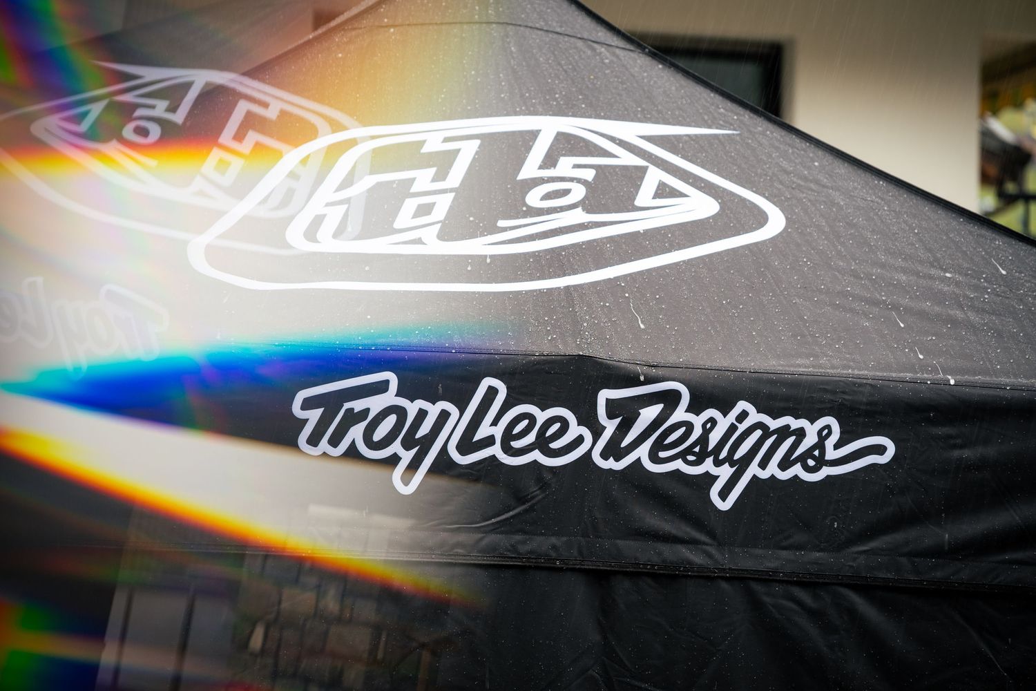 Troy Lee Designs branded black canopy tent displayed outdoors with iconic logo and signature script lettering.