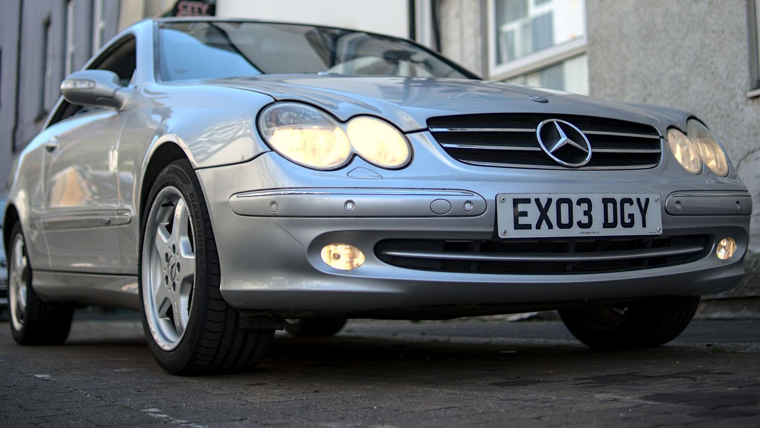 Close-up front view of a silver Mercedes-Benz CLK with license plate EX03 DGY.