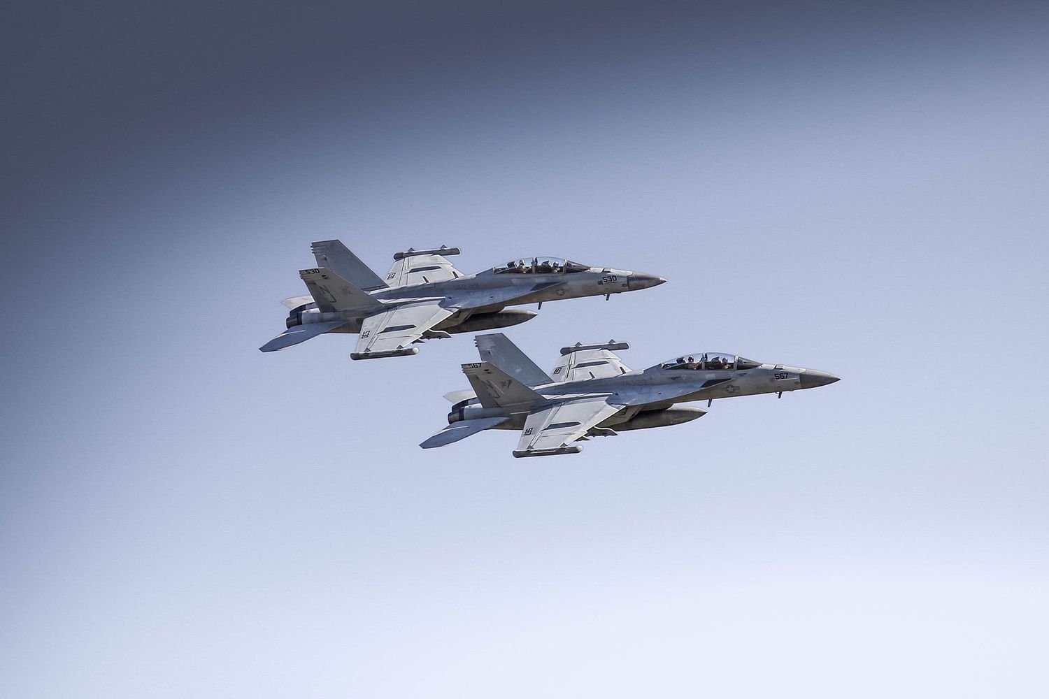 Two EA 18 Growlers fly next to each while performing a low altitude pass at the 2025 McMinnville Air Show in McMinnville Oregon.