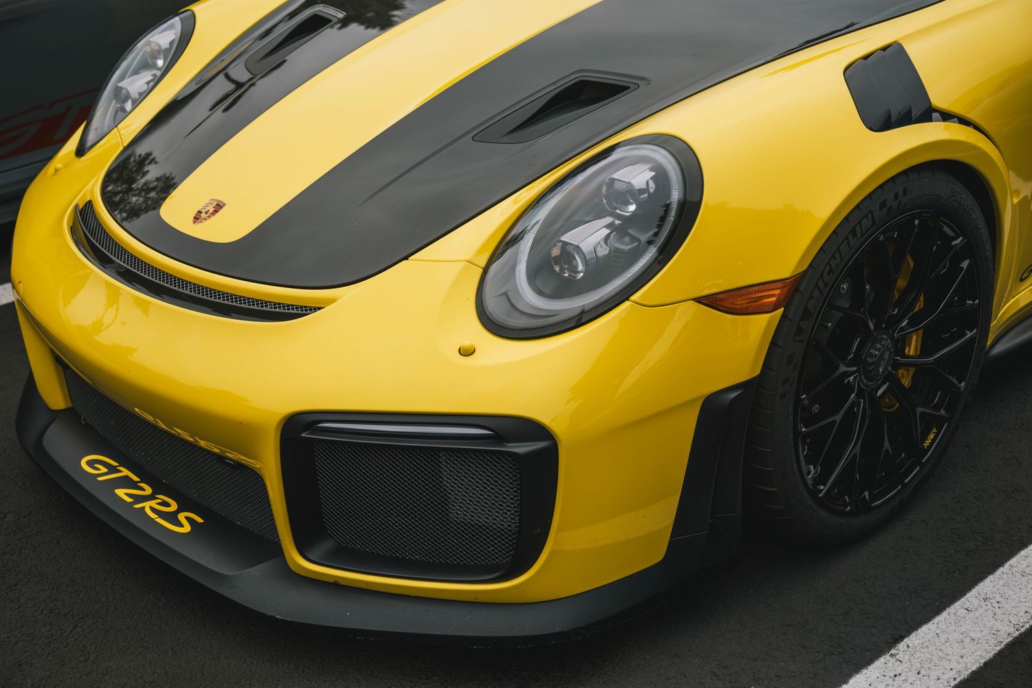 991 GT2 RS in Signal Yellow with exposed carbon fiber hood and PCCBs in yellow.