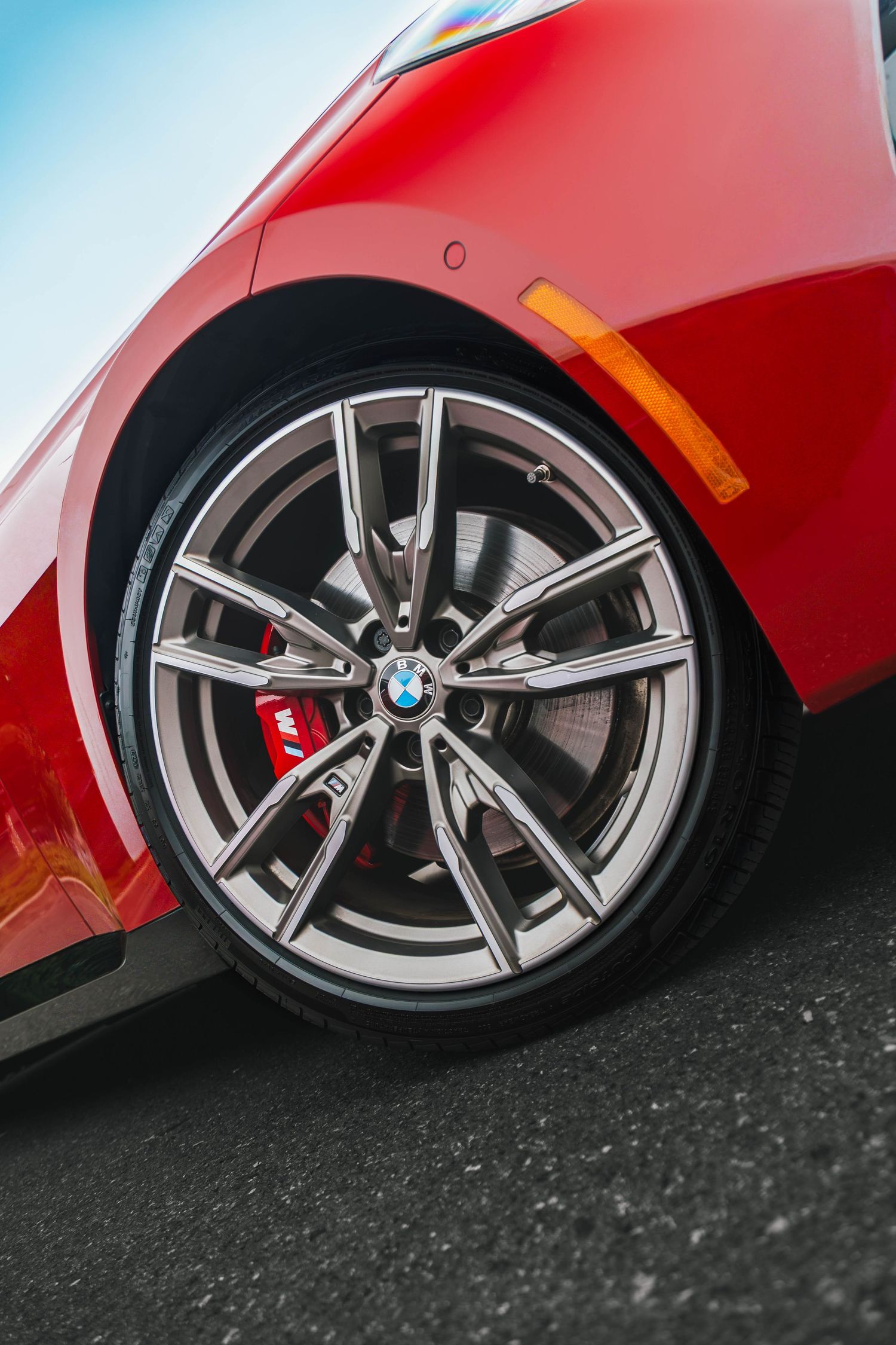 BMW M240i Front wheel and performance brake in red.