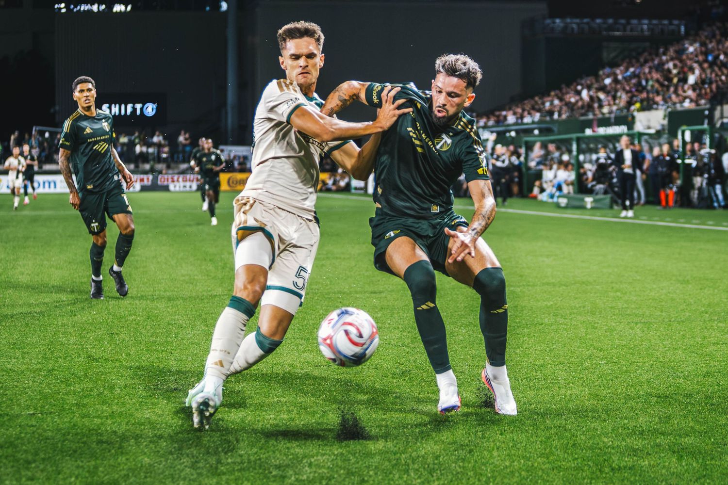 Portland Timbers players competing against Atlanta United FC during a Major League Soccer match at Providence Park in Portland, Oregon.