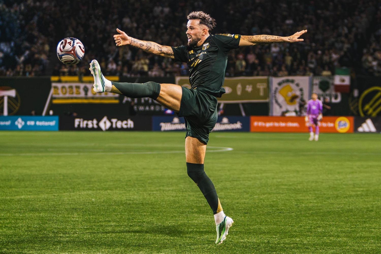 Portland Timbers players competing against Atlanta United FC during a Major League Soccer match at Providence Park in Portland, Oregon.
