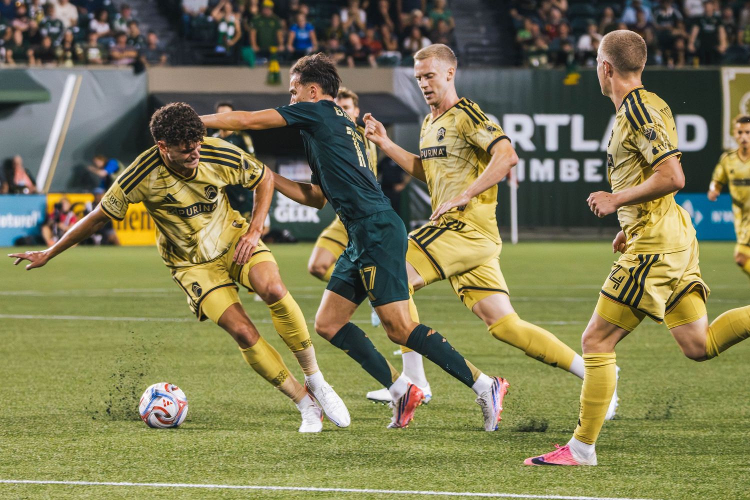 Portland Timbers players competing against St. Louis CITY SC during a Major League Soccer match at Providence Park in Portland, Oregon.