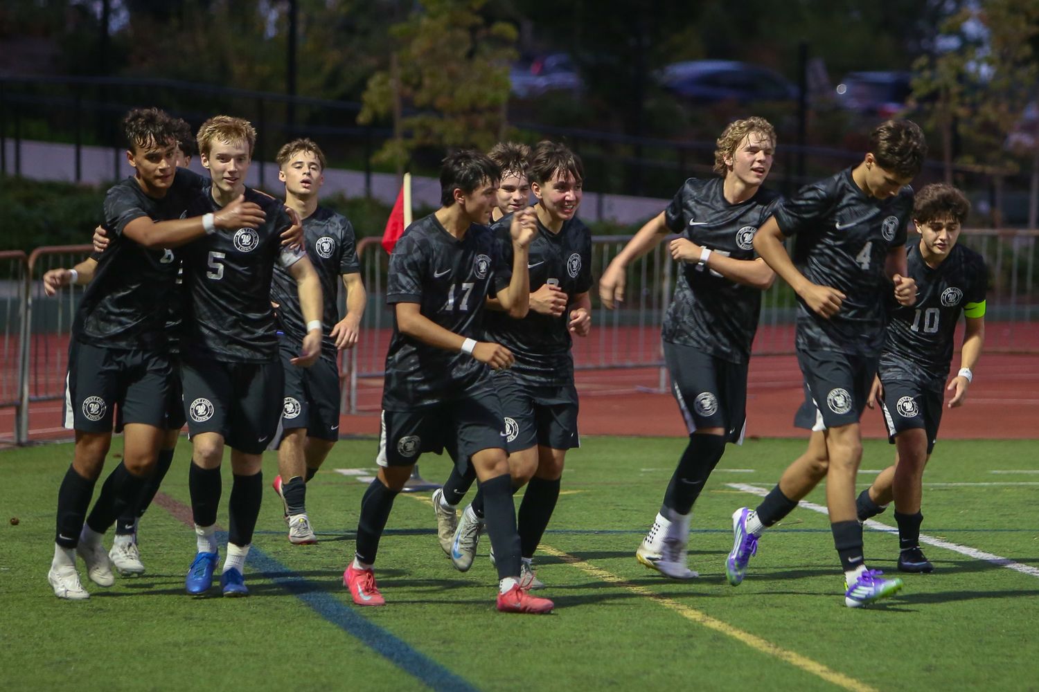 West Linn Varsity soccer celebrates a goal.