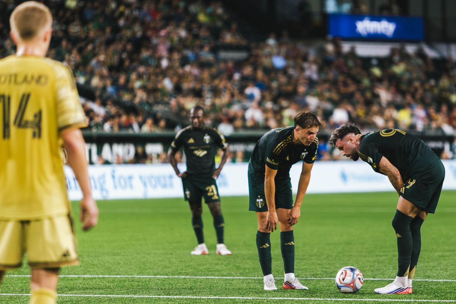 Portland Timbers players competing against St. Louis CITY SC during a Major League Soccer match at Providence Park in Portland, Oregon.