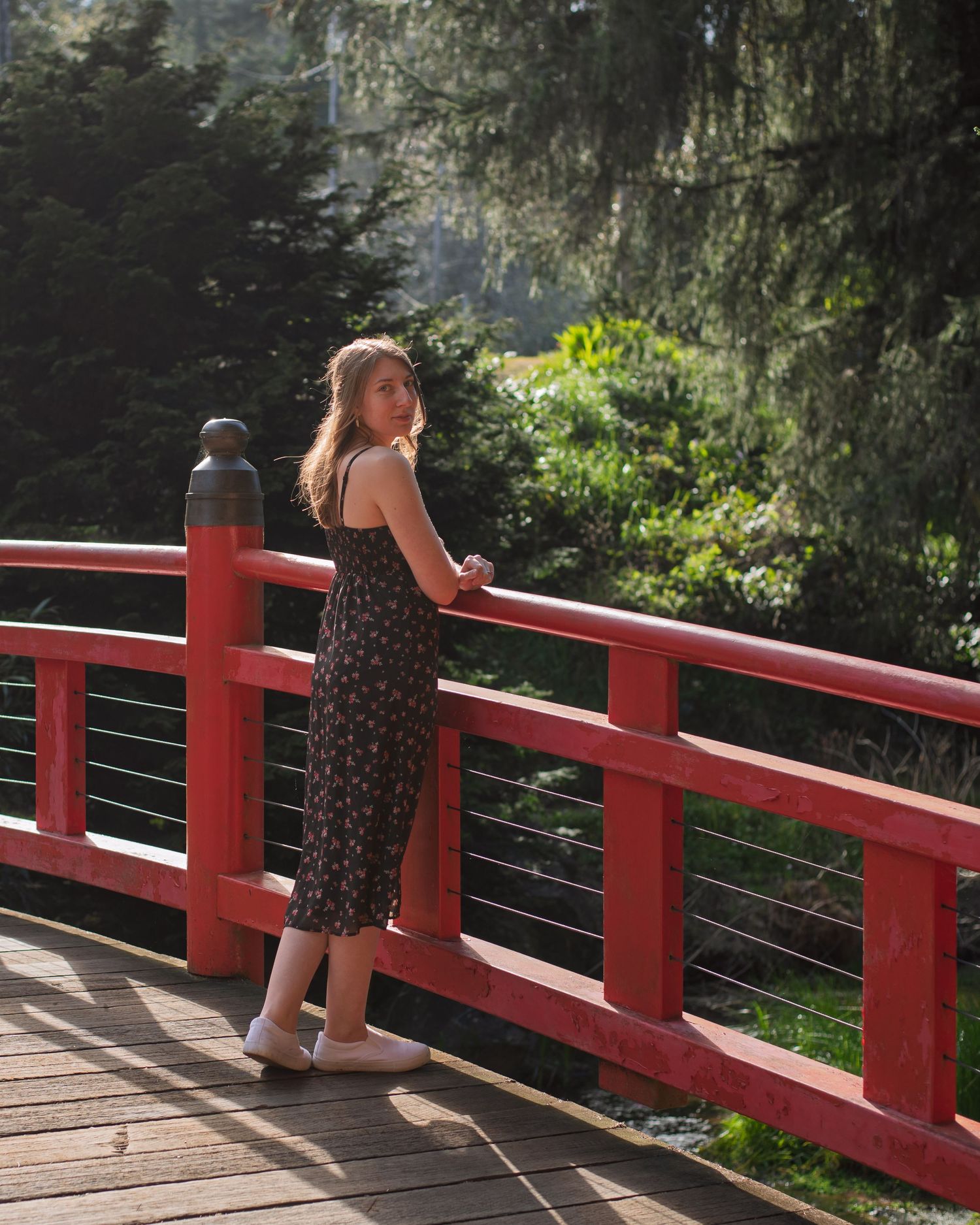 A photo of a woman standing on a bridge.
