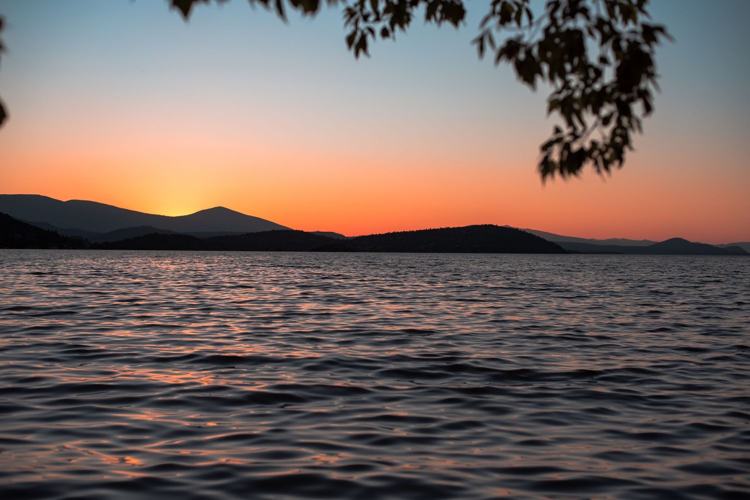 A photo of a body of water during sunset.