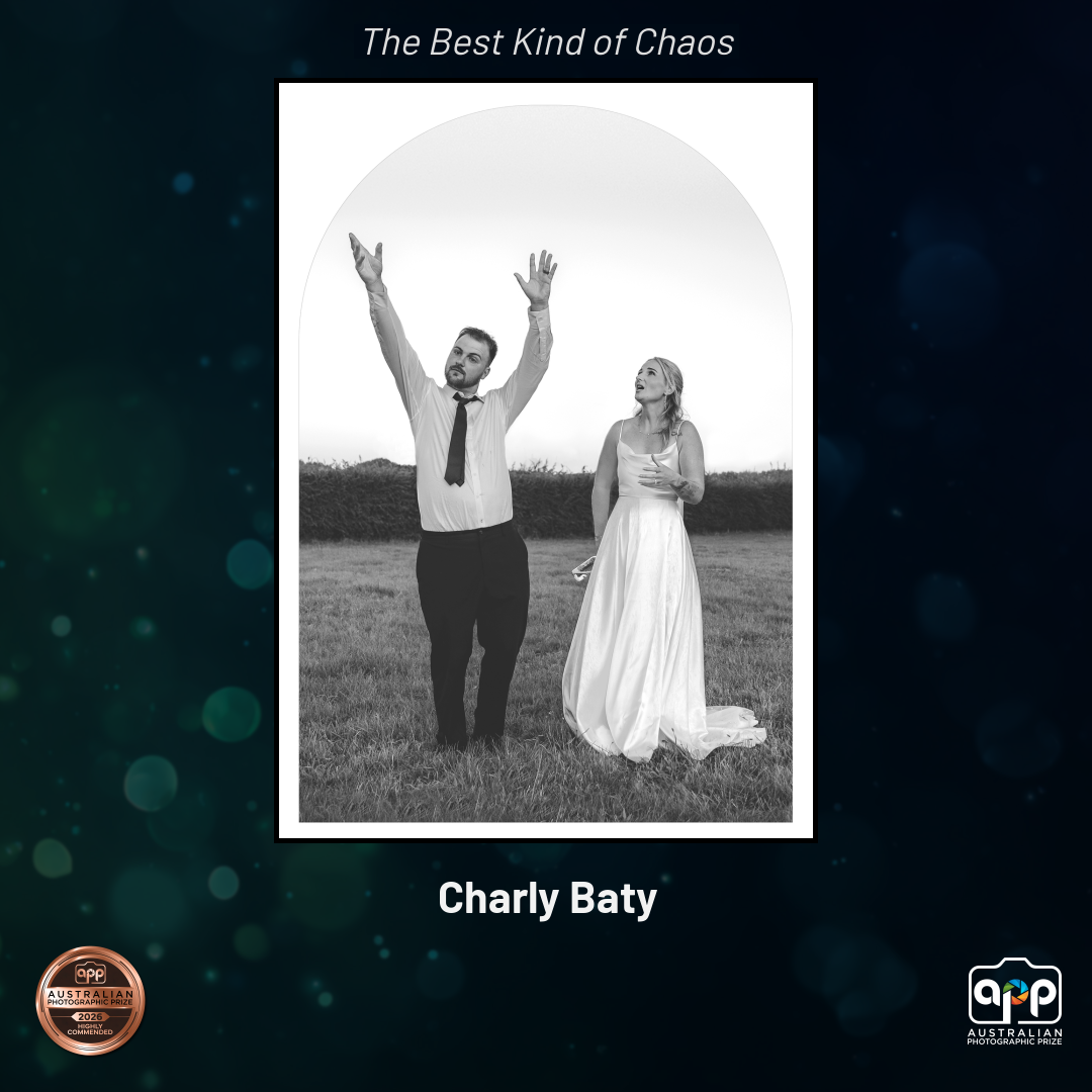Black and white wedding photo of couple celebrating outdoors, titled The Best Kind of Chaos by photographer Charly Baty.