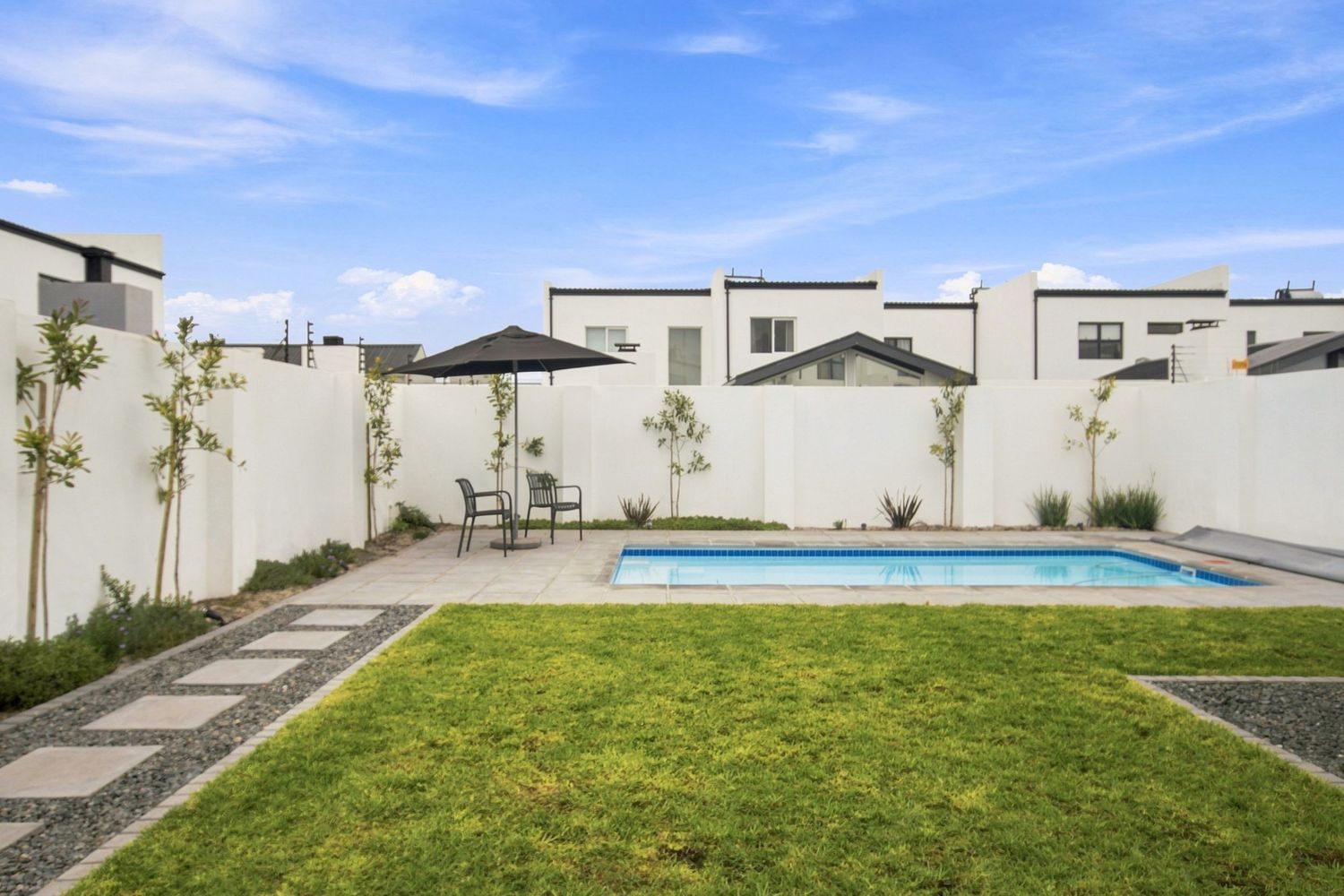 Residential backyard lawn and swimming pool real estate photography