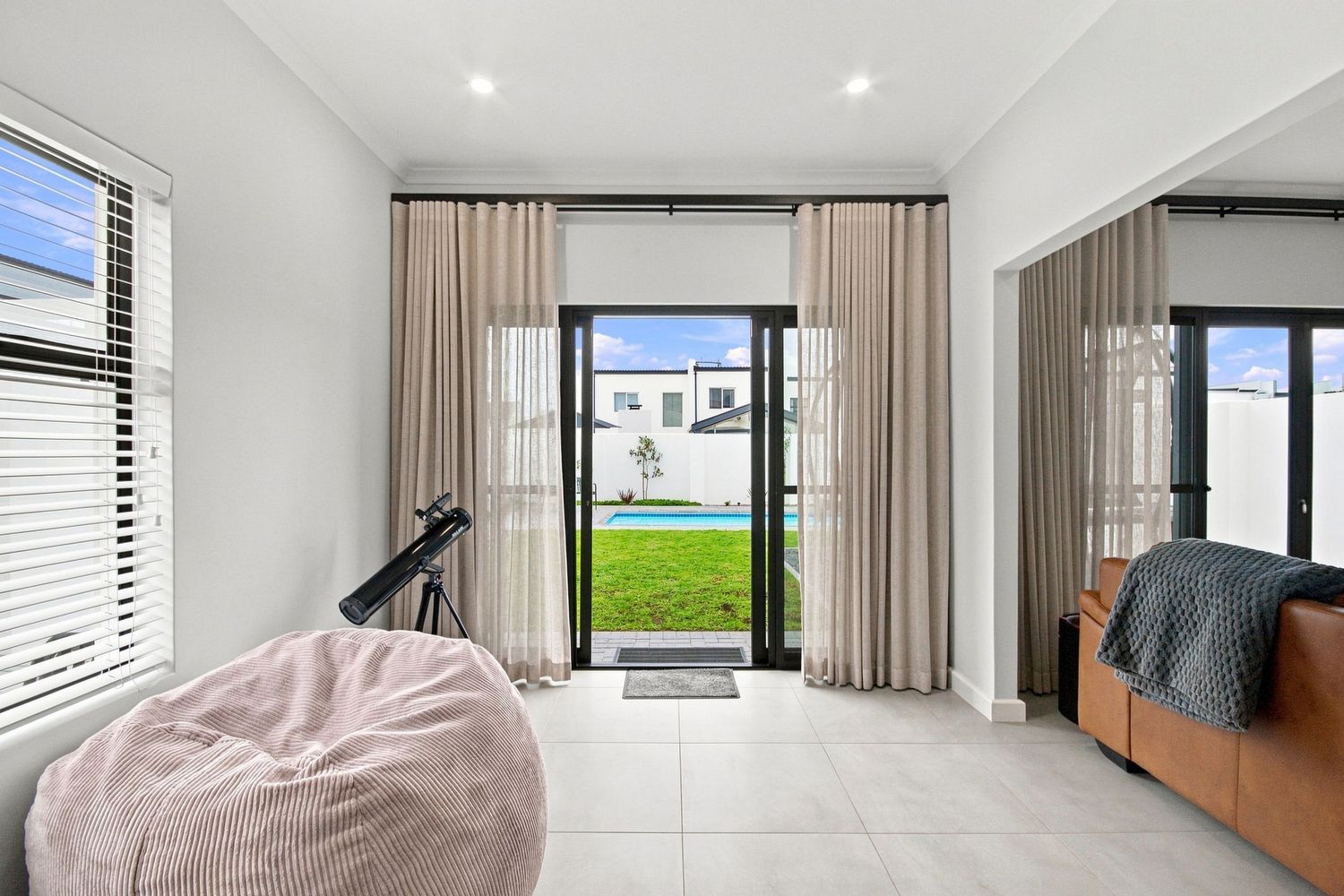 Bright residential interior bedroom leading to outdoor patio area
