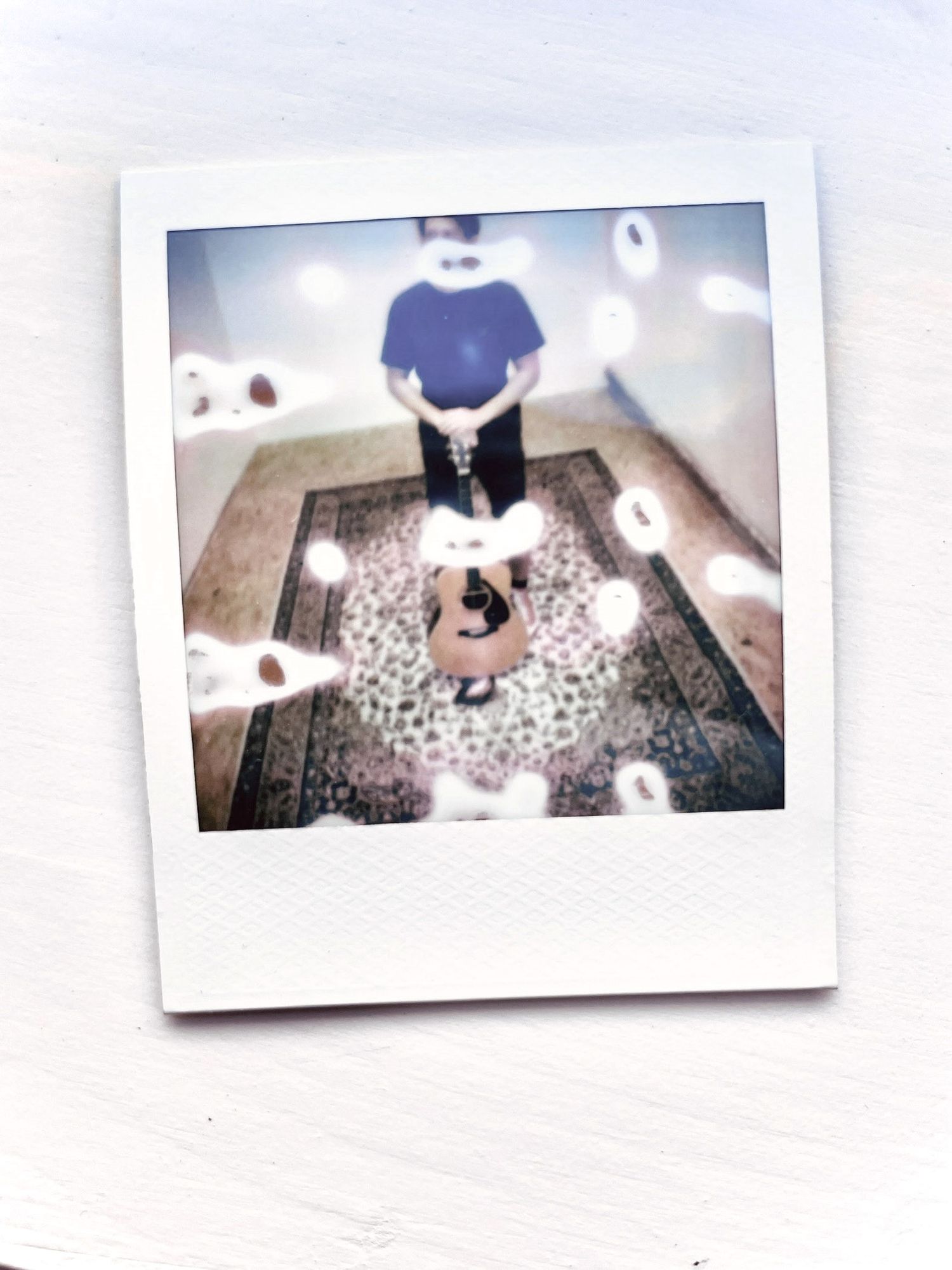 Instax picture of a man with guitar