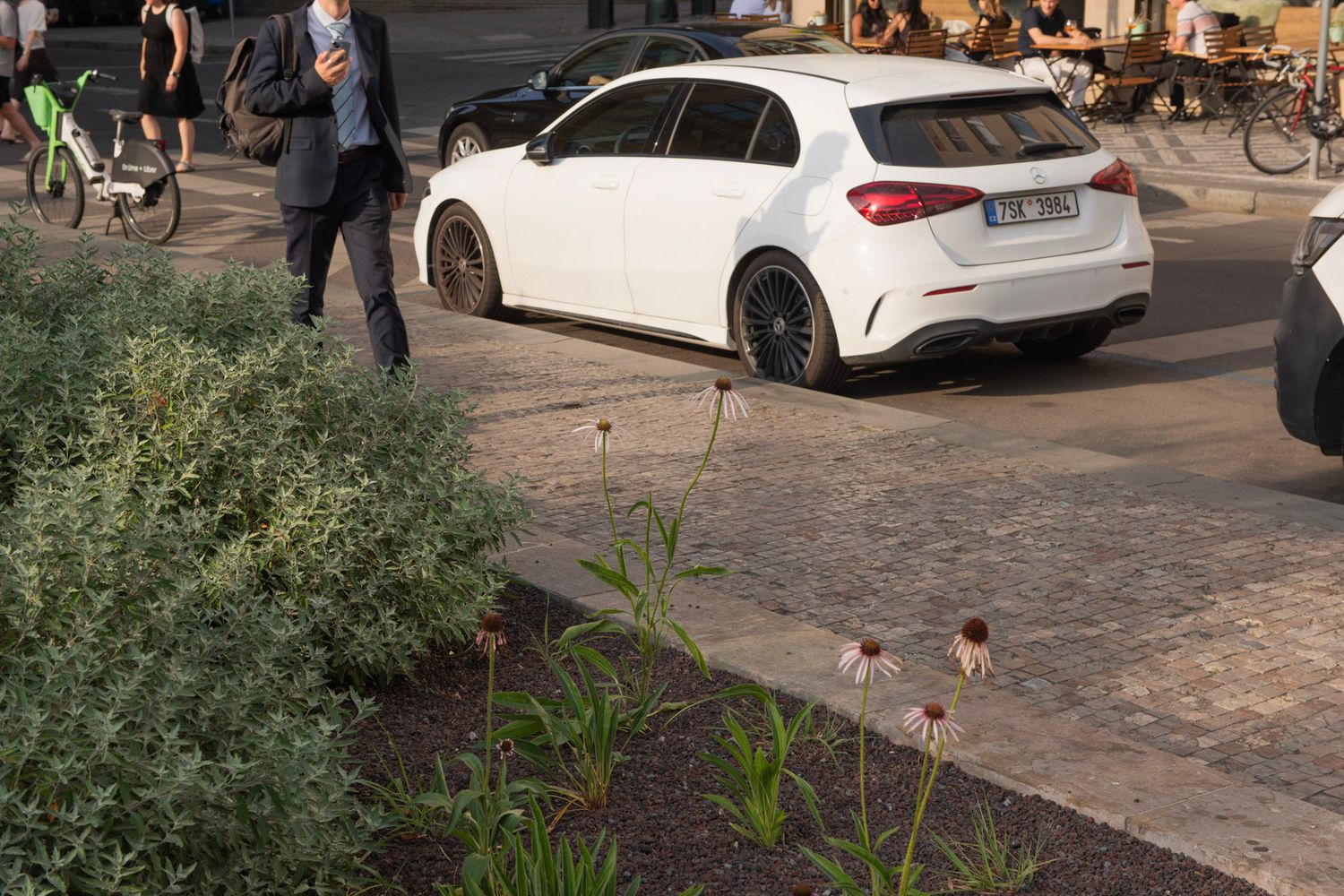 A man in a suit and his shadow on the car