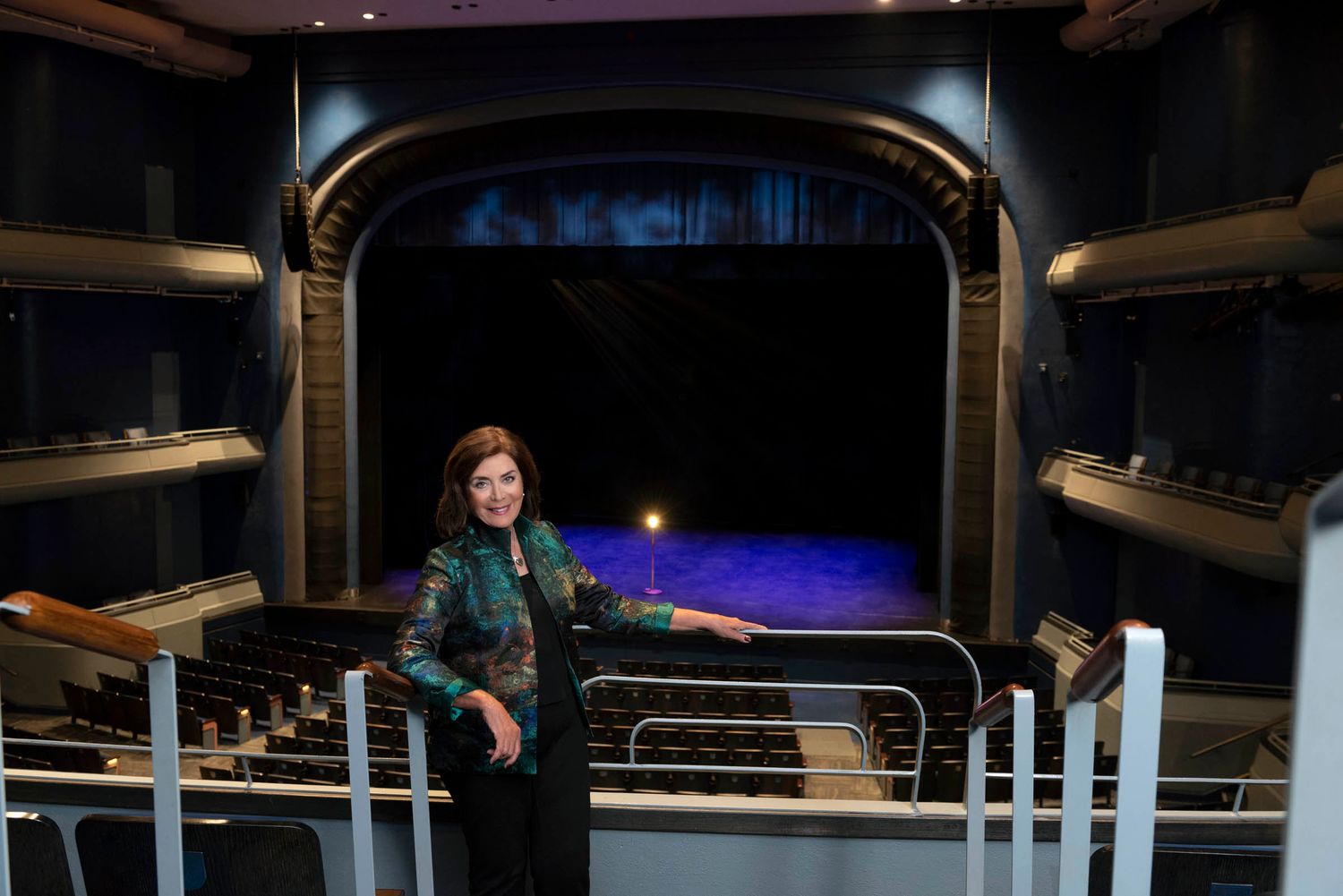 Business portrait photography Tampa FL — former Straz Center president on balcony overlooking lit stage