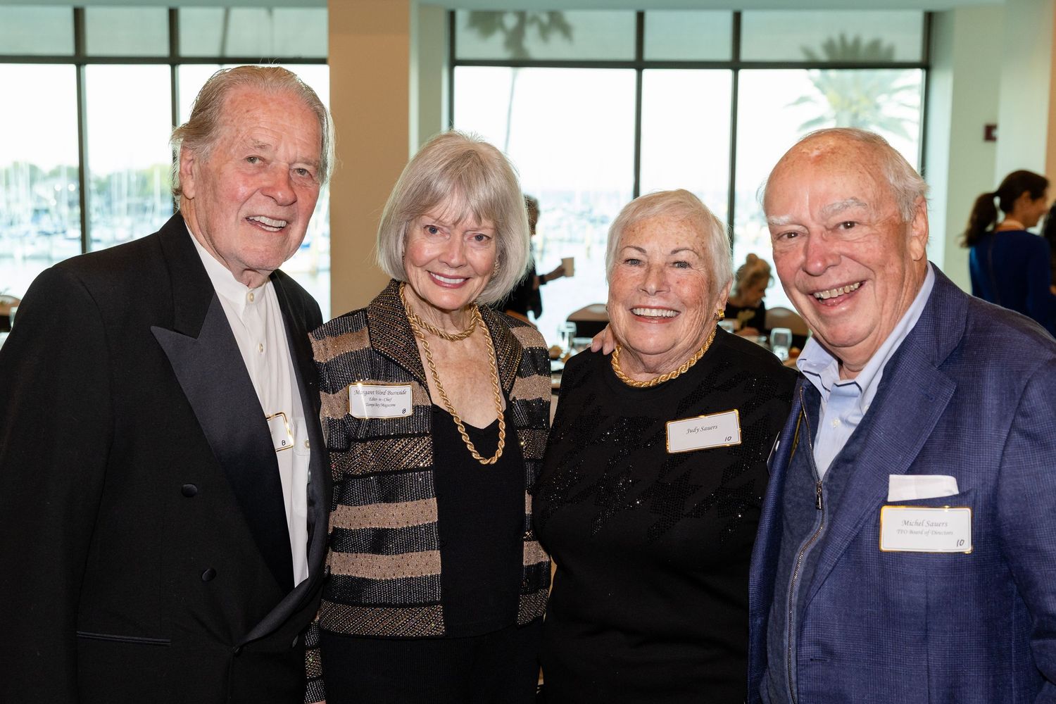 Two smiling couples pose together at The Florida Orchestra 57th Annual Golden Baton Award gala event.
