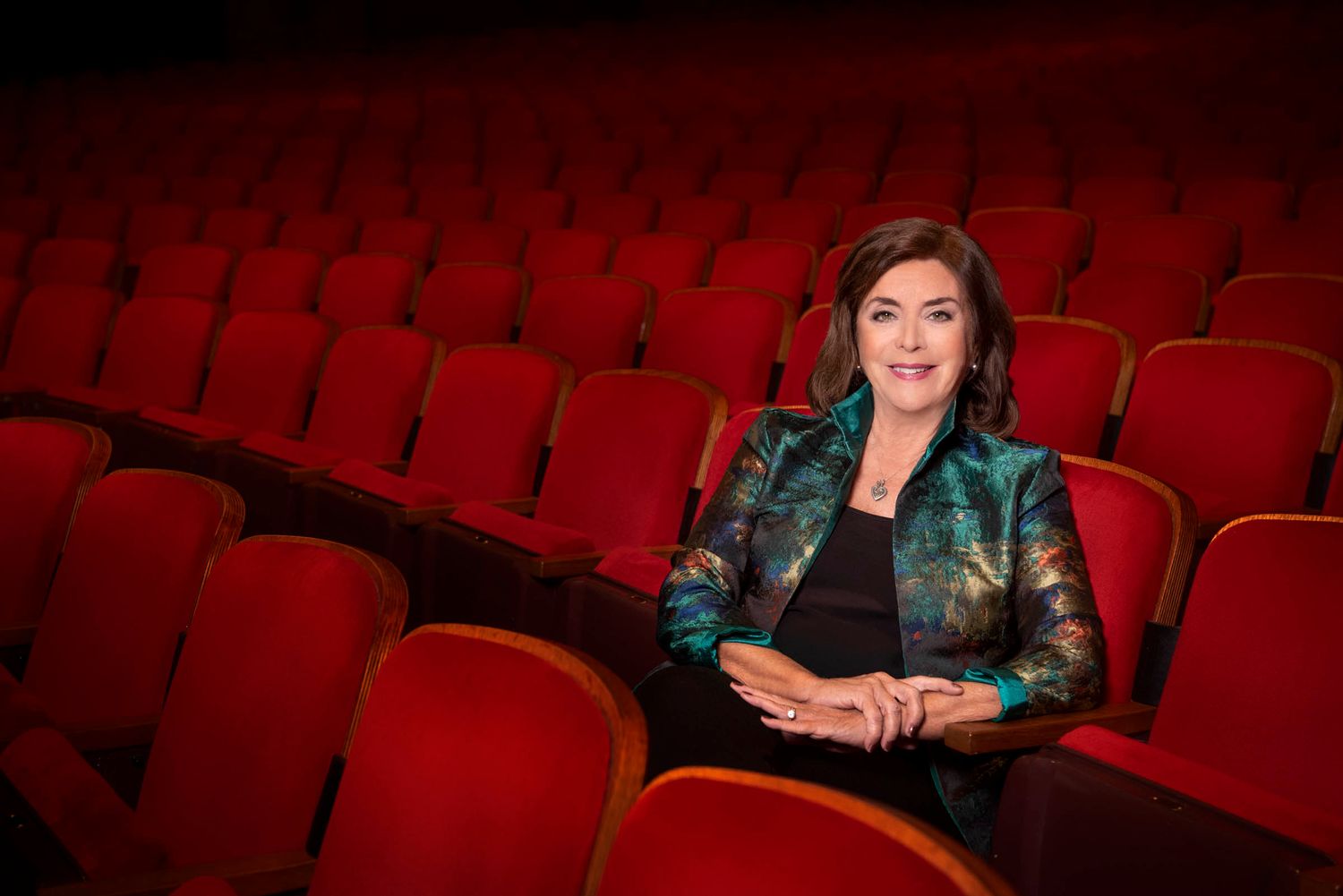 Corporate headshot photographer Tampa Bay — former Straz Center president seated in theater audience