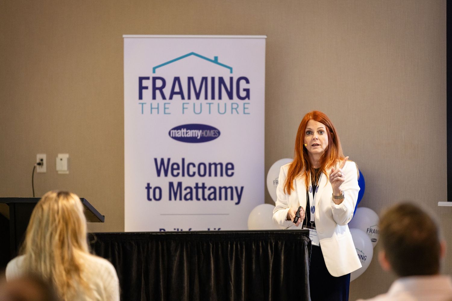 Woman presenting at Mattamy Homes Framing the Future welcome event at a corporate conference.