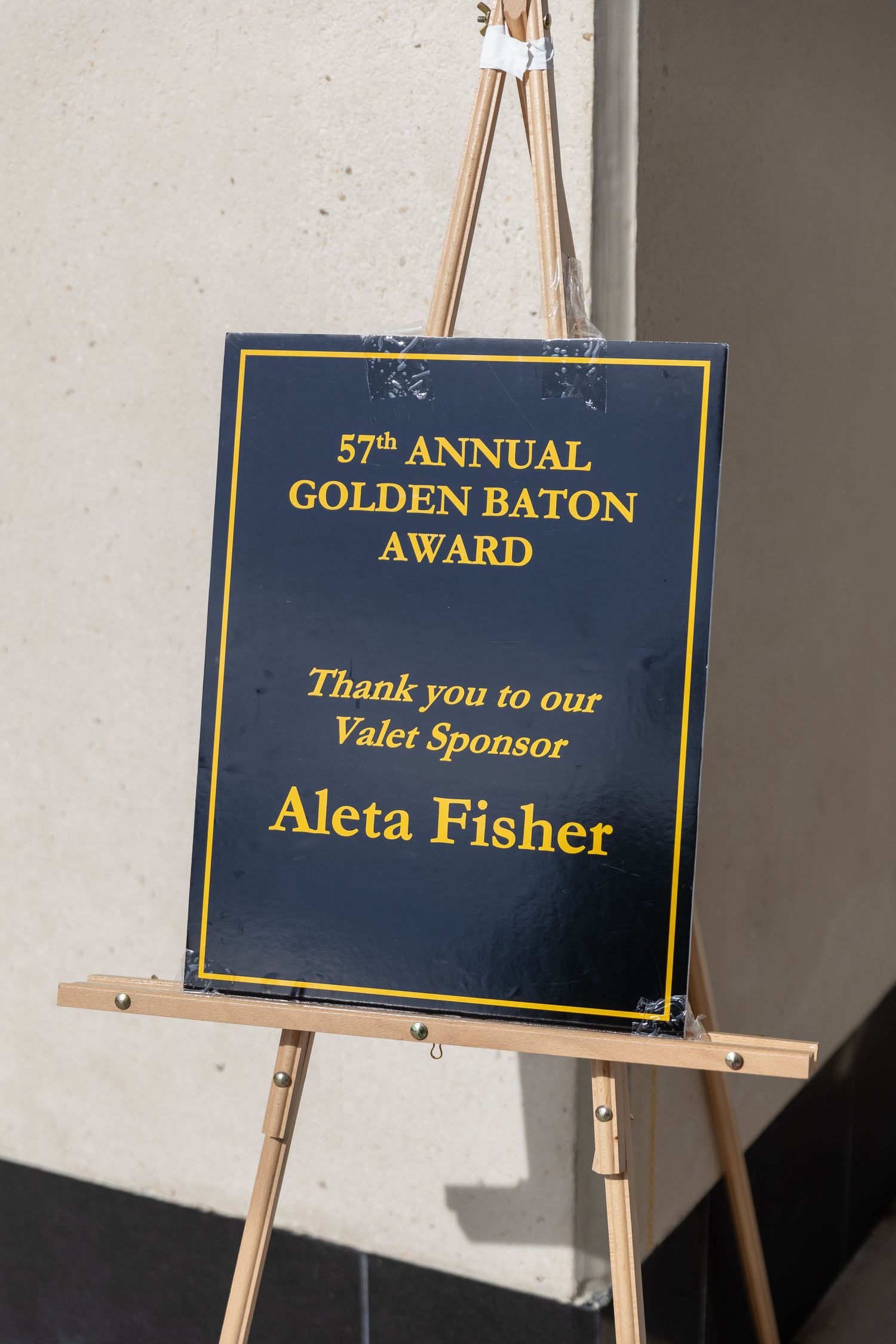Sign on easel for 57th Annual Golden Baton Award thanking valet sponsor Aleta Fisher.