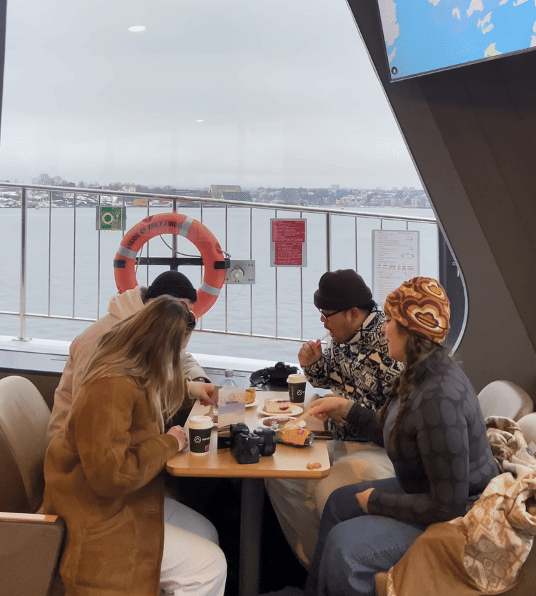 Gif of 4 people enjoying the views from a boat.