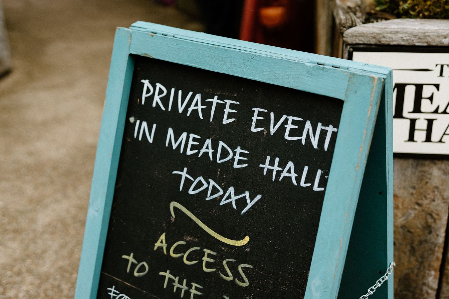 A chalkboard sign announces a private event in Meade Hall today at a wedding venue.