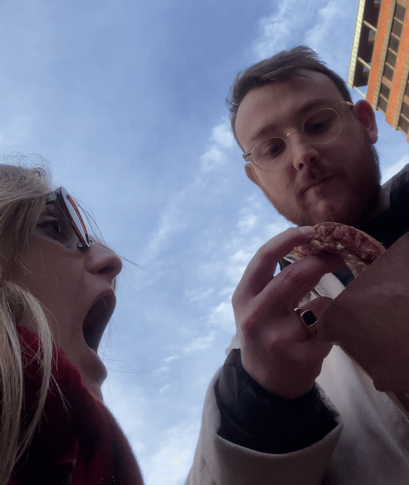 Gif of a couple eating cinnamon rolls.