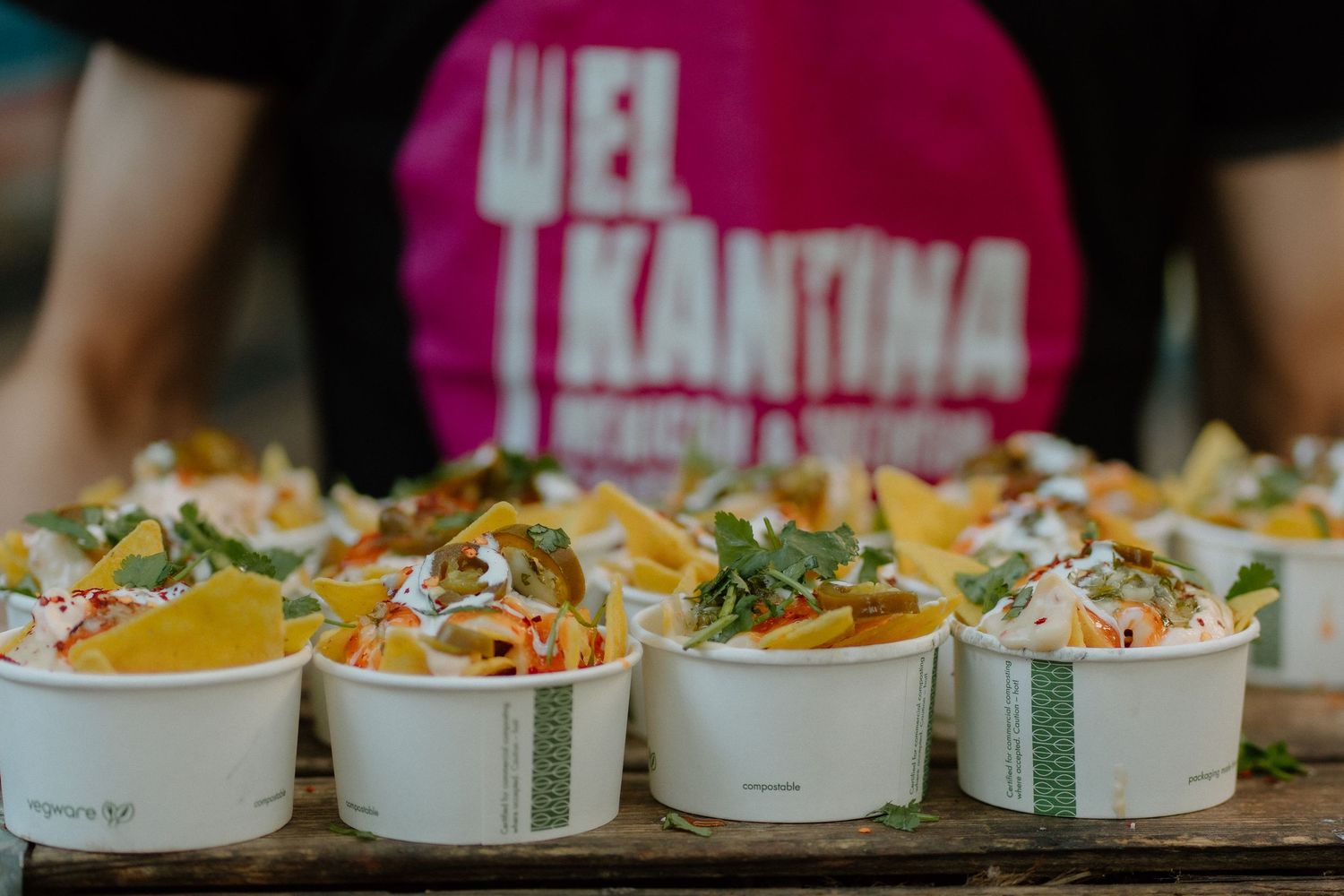 Mexican food bowls with colorful toppings arranged on a serving tray.