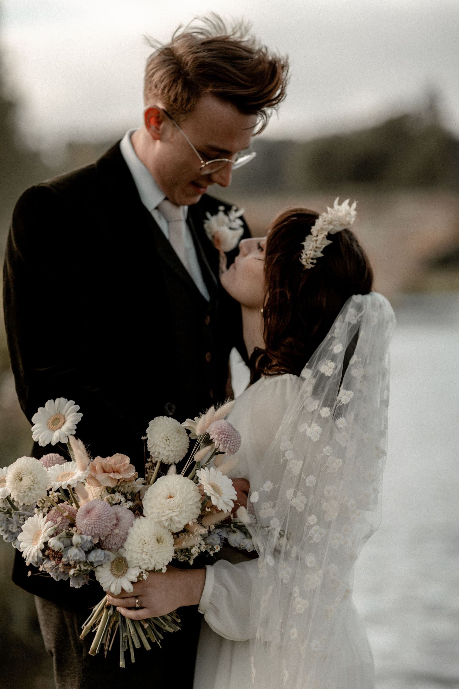 An intimate wedding moment captured with soft lighting and delicate floral details.