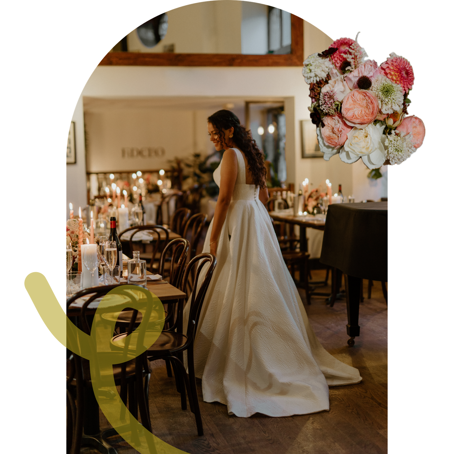 Bride in elegant white ballgown stands beside candlelit reception tables in a warmly lit wedding venue.