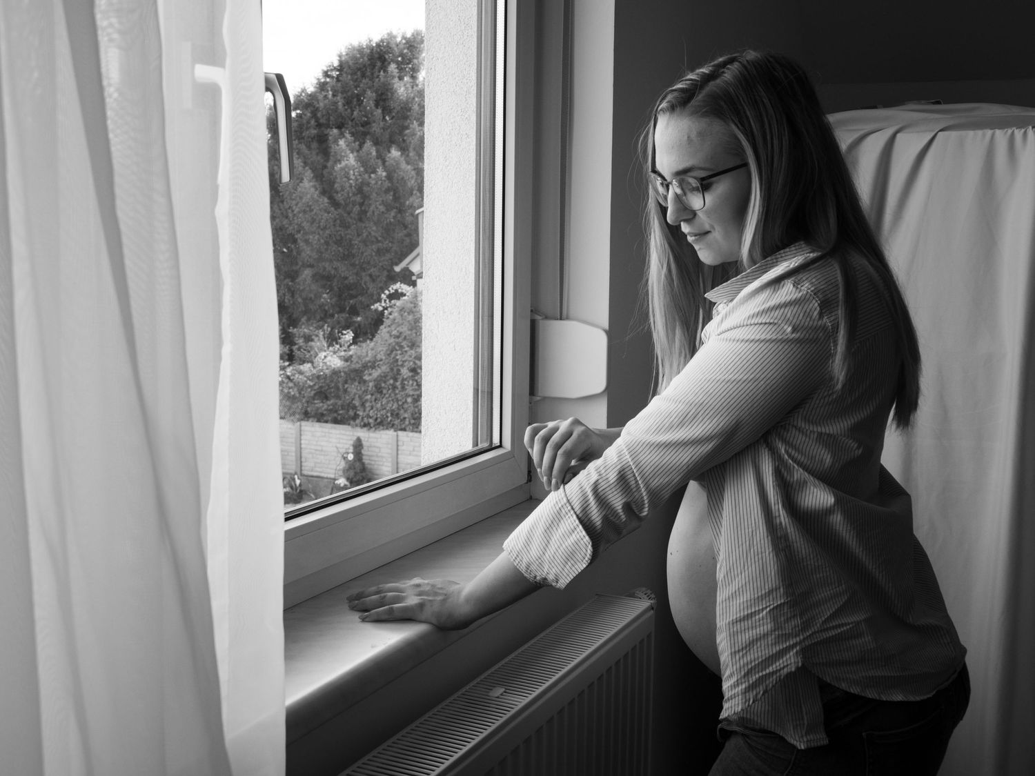 Black and white moody window portraits showing contemplative silhouettes.