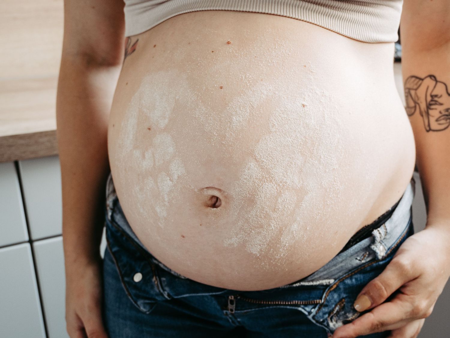 Close-up progression shots showing a pregnant belly during different stages of pregnancy.