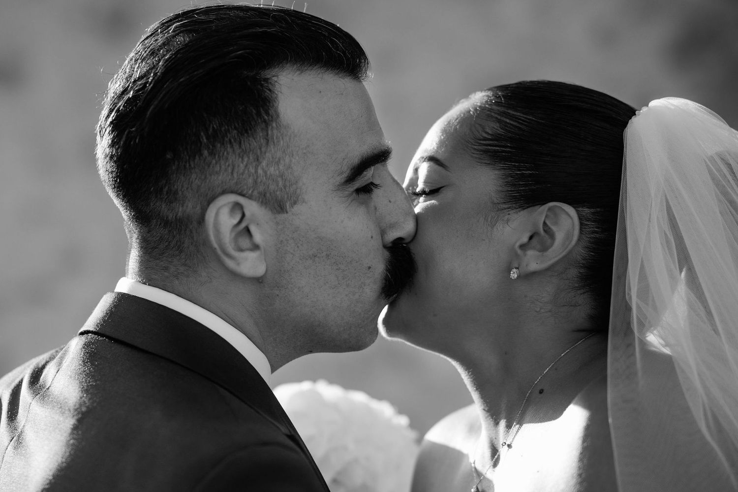 Close-up black and white romantic moments at a wedding celebration.