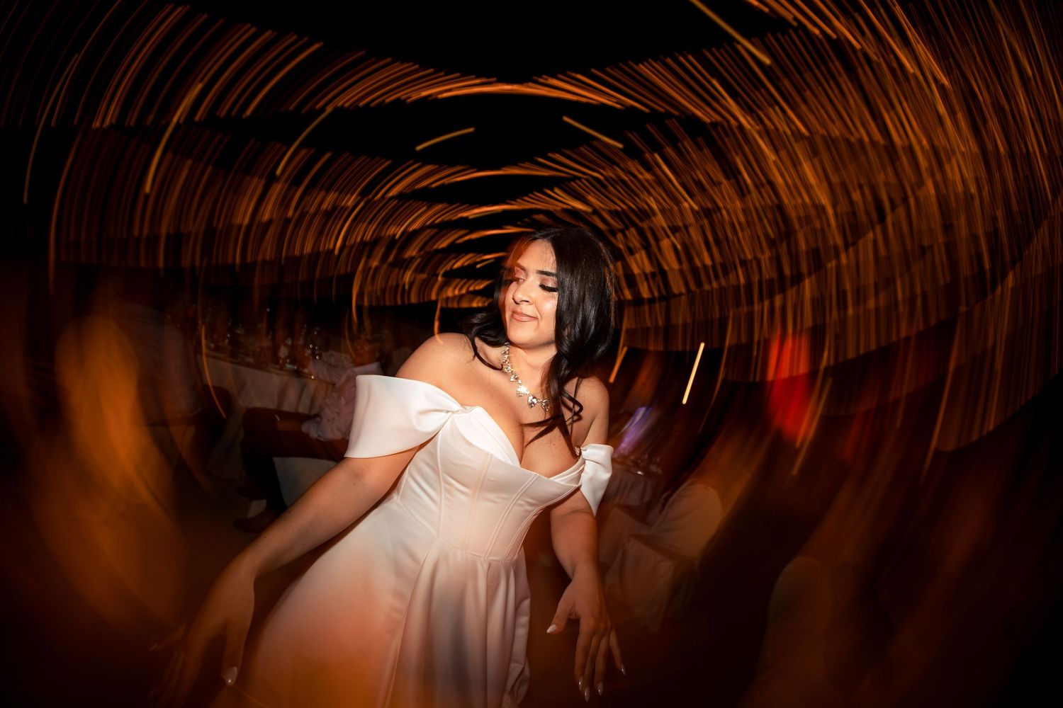 Dramatic overhead shot of a dance floor with string lights creating circular patterns in the dark.