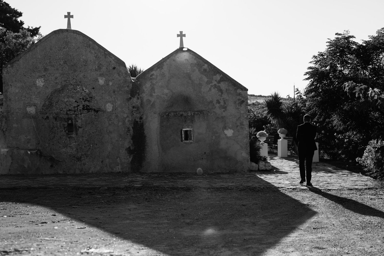 Black and white panoramic series of a rural church with cross on top.