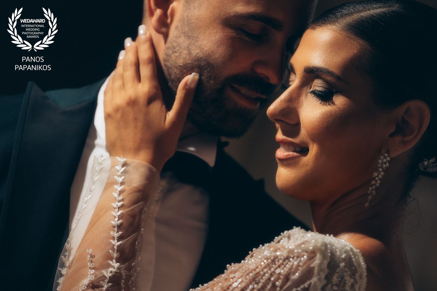 Romantic couple sharing intimate moments in an elegant indoor setting.