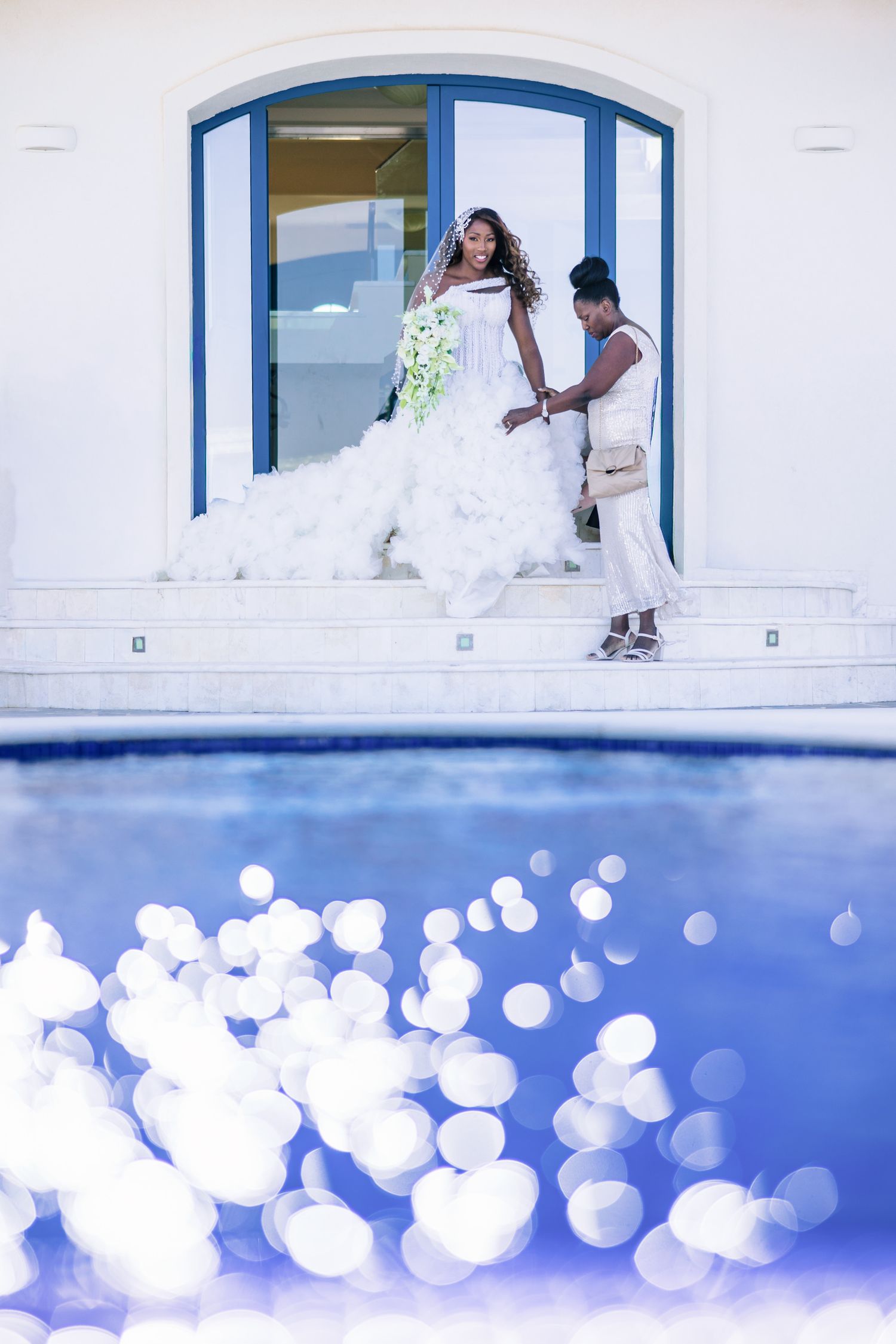 Creative underwater view of a white building with blue accents and floating bokeh effects.