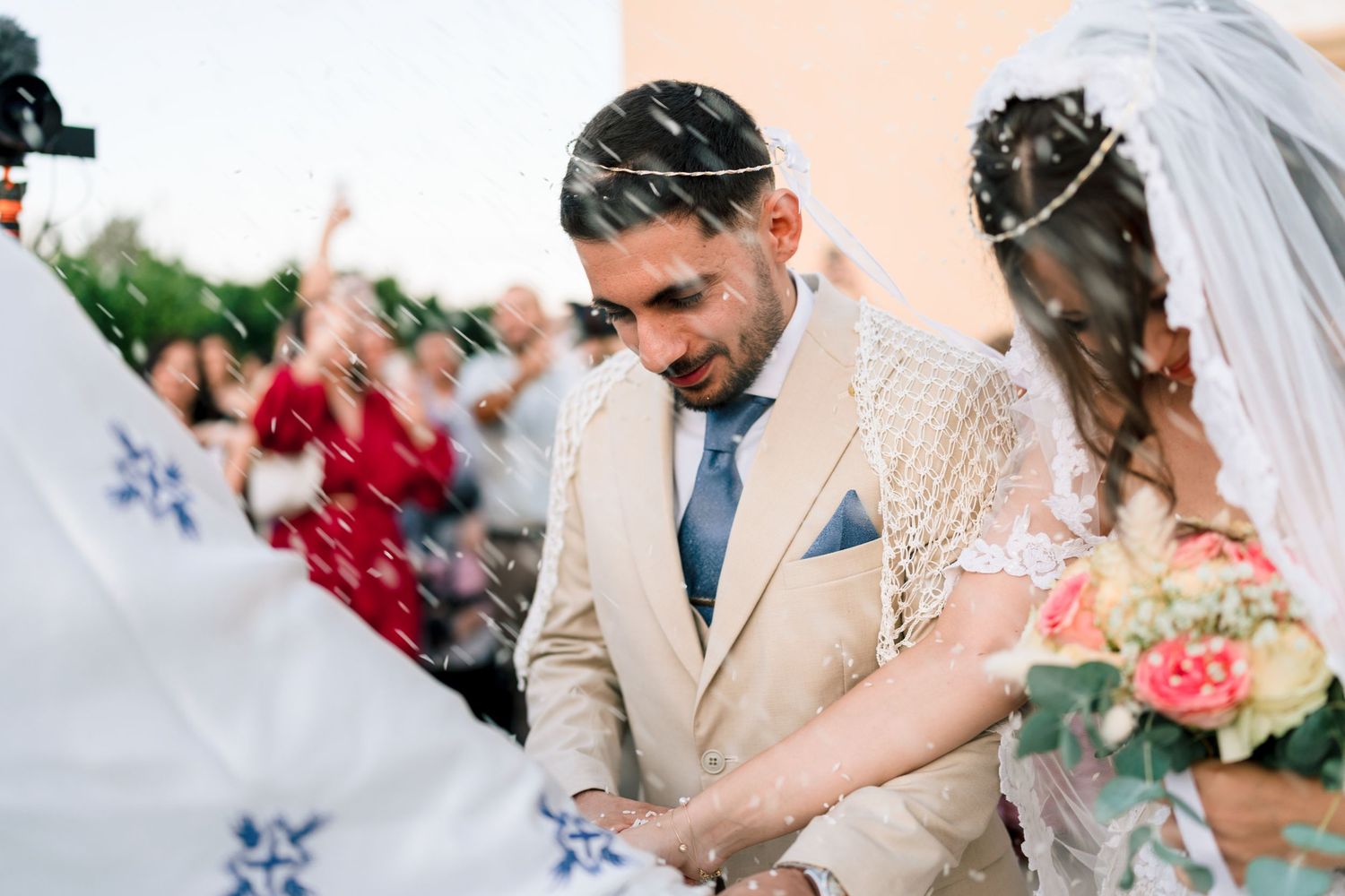 Joyful celebration moments captured during outdoor wedding reception with floral details.