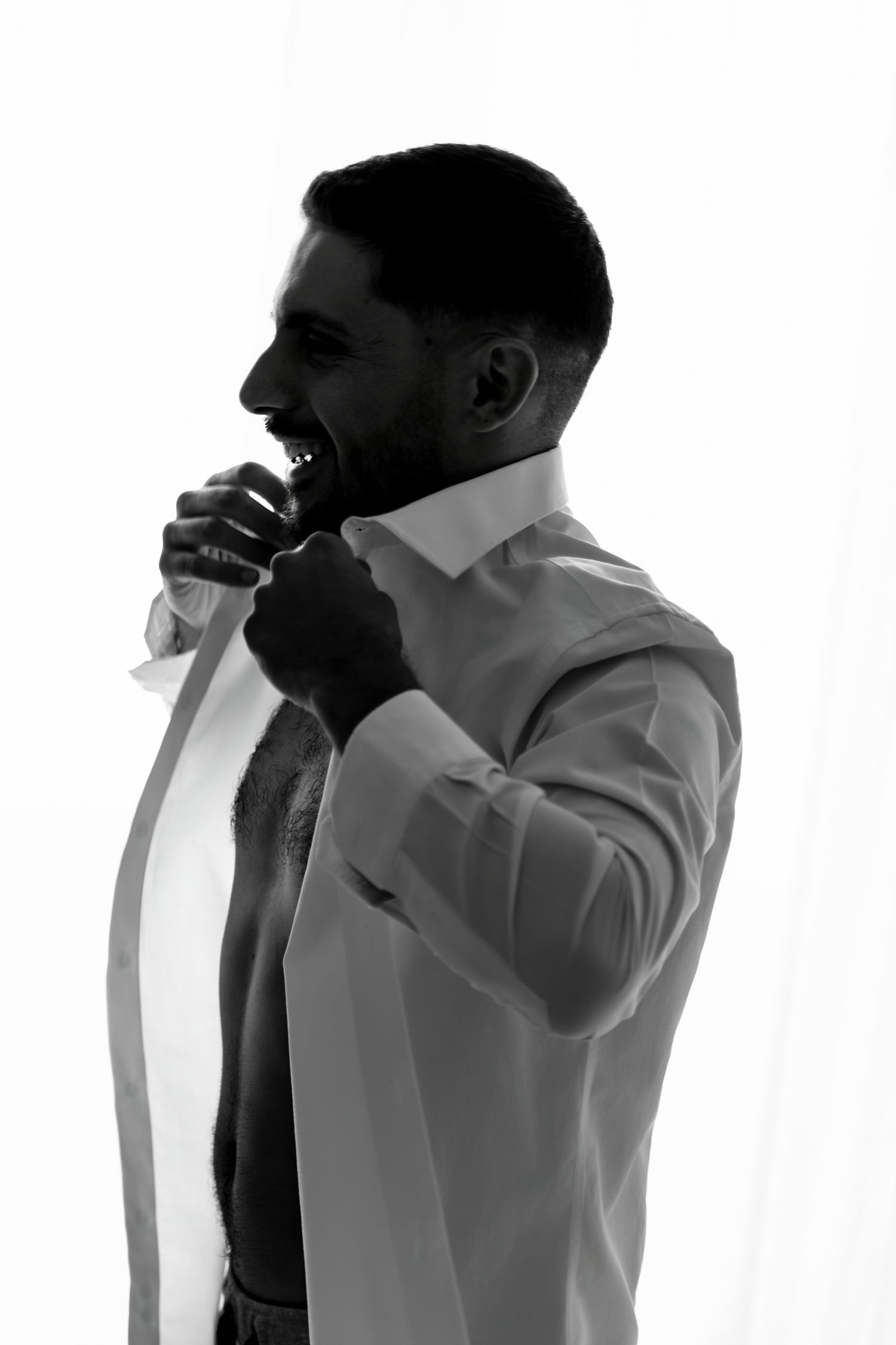 Black and white profile silhouettes of person in formal attire.