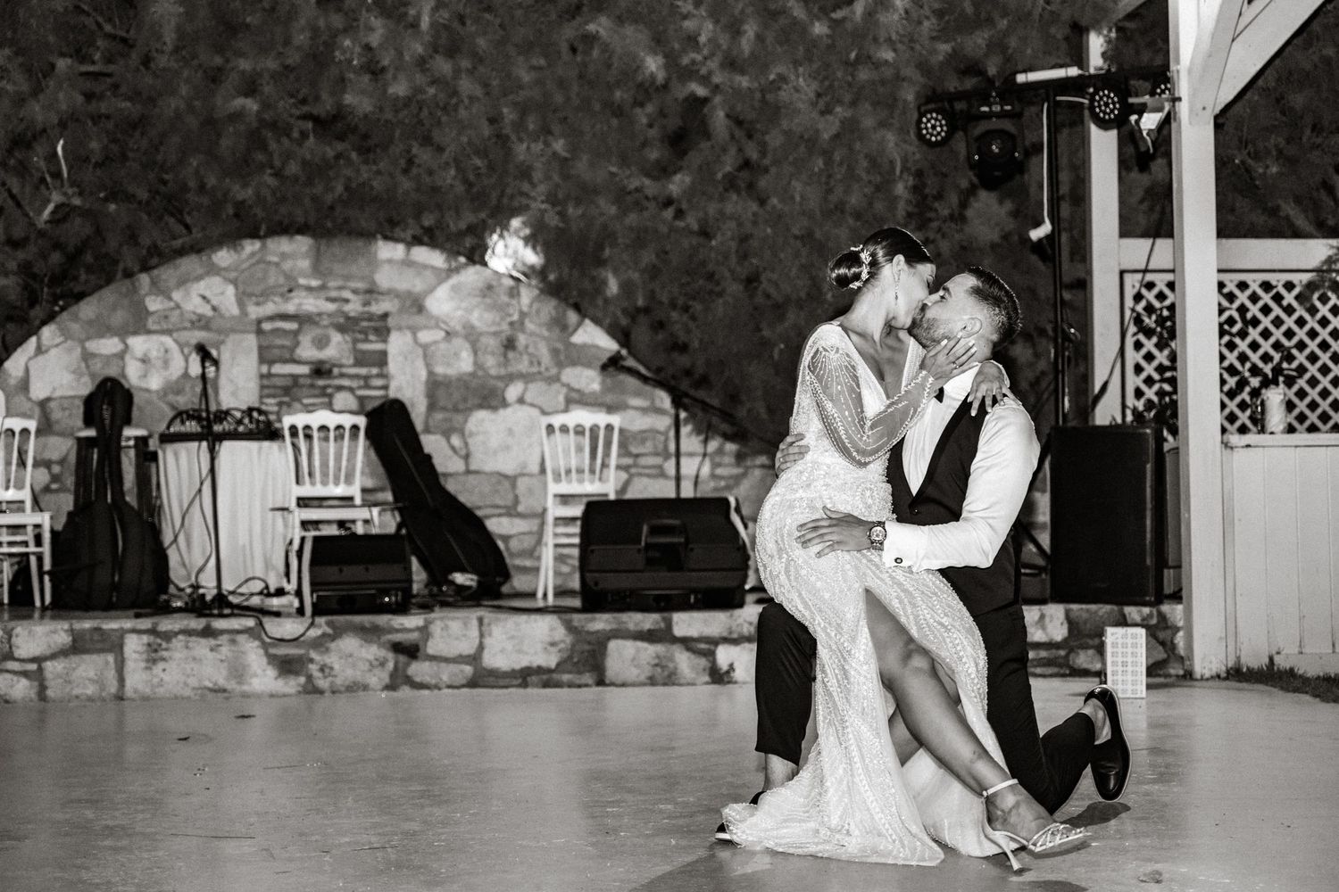 Couple dancing together during their first dance at an outdoor wedding reception.