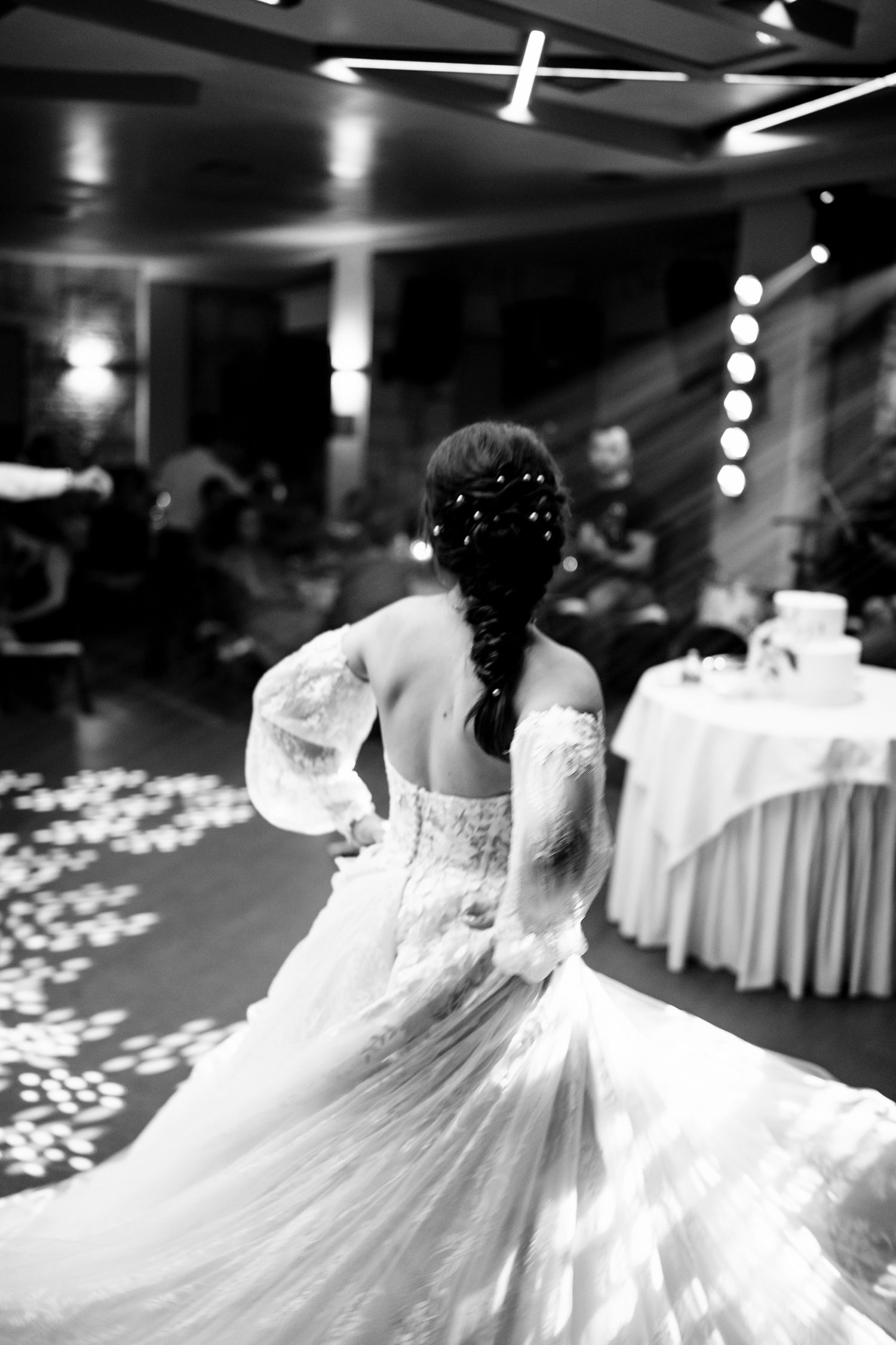 Multiple views of bride twirling in white wedding dress during first dance.