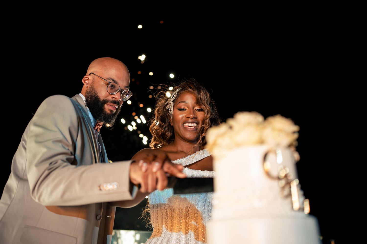 Wedding celebration with sparklers and smoke effects creating a magical atmosphere.