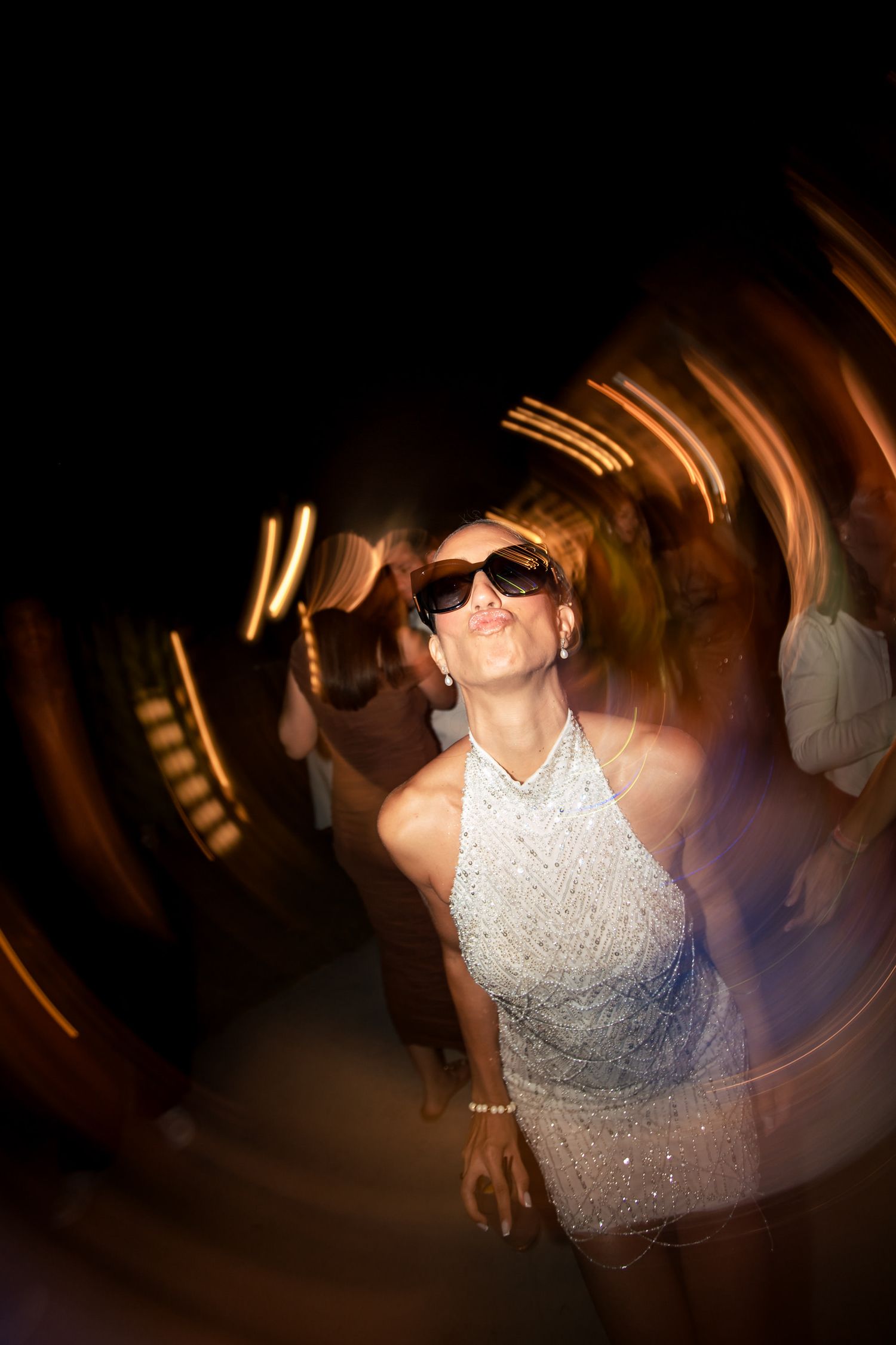 Dynamic party scene with motion blur and dramatic lighting effects at a celebration.