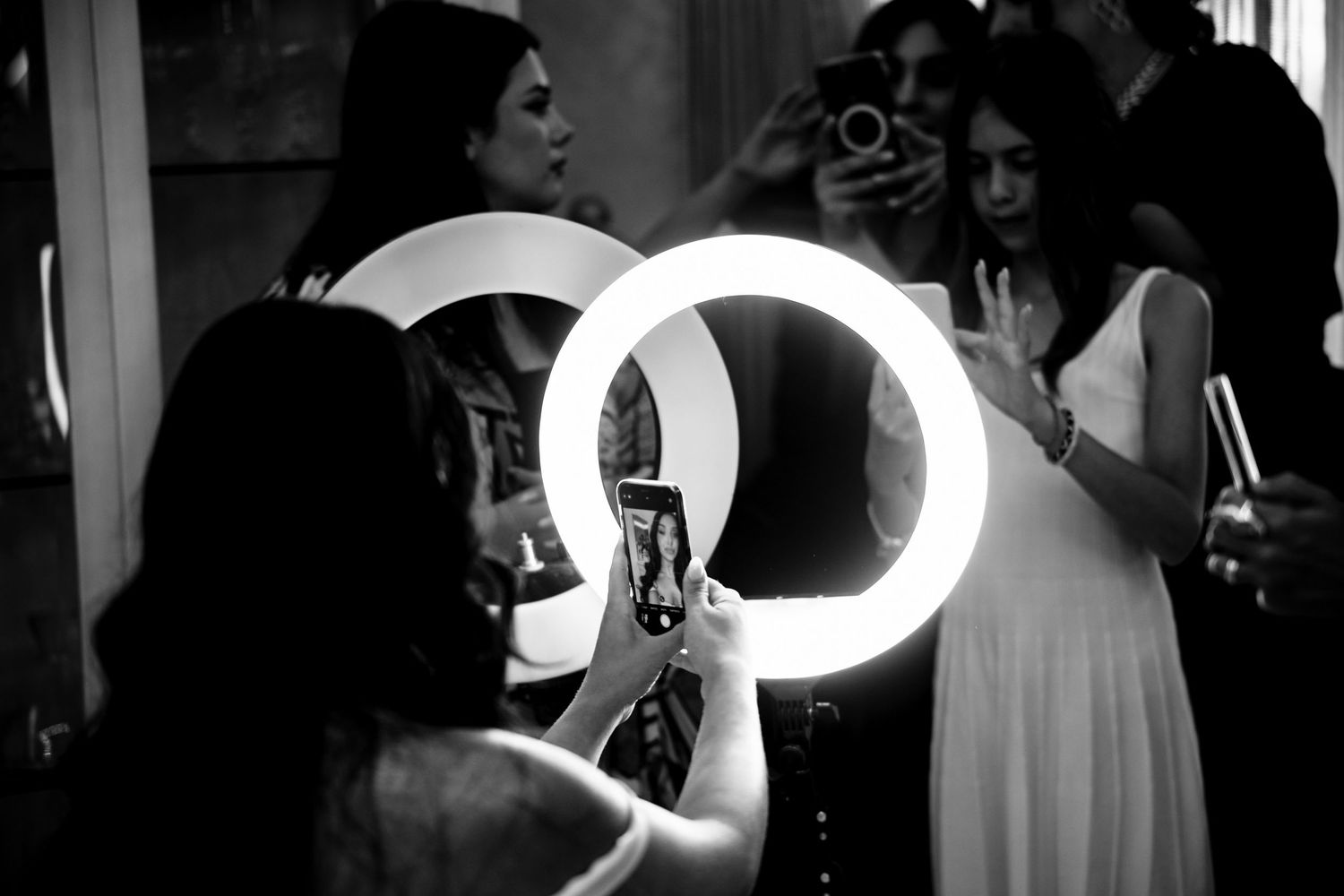Ring light creates dramatic lighting in salon preparation scene.