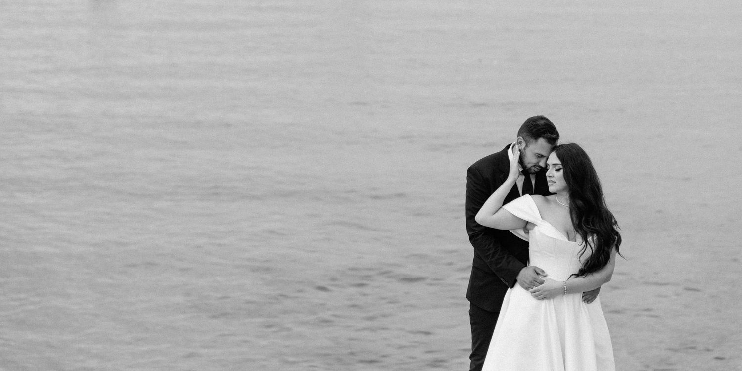 Black and white wedding photo of couple embracing on a misty day.