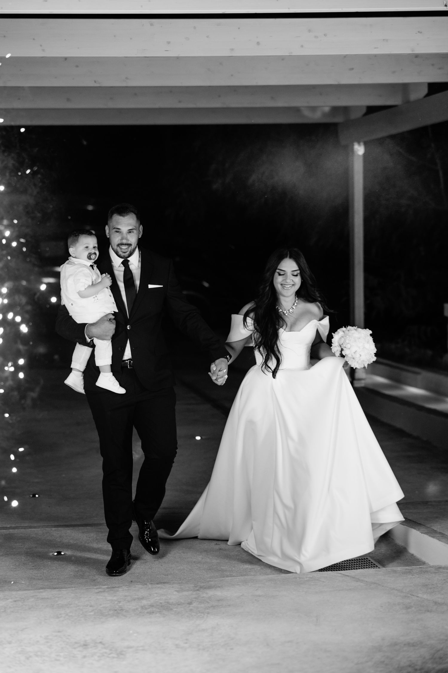 Black and white photos capture playful moments during an evening wedding celebration.