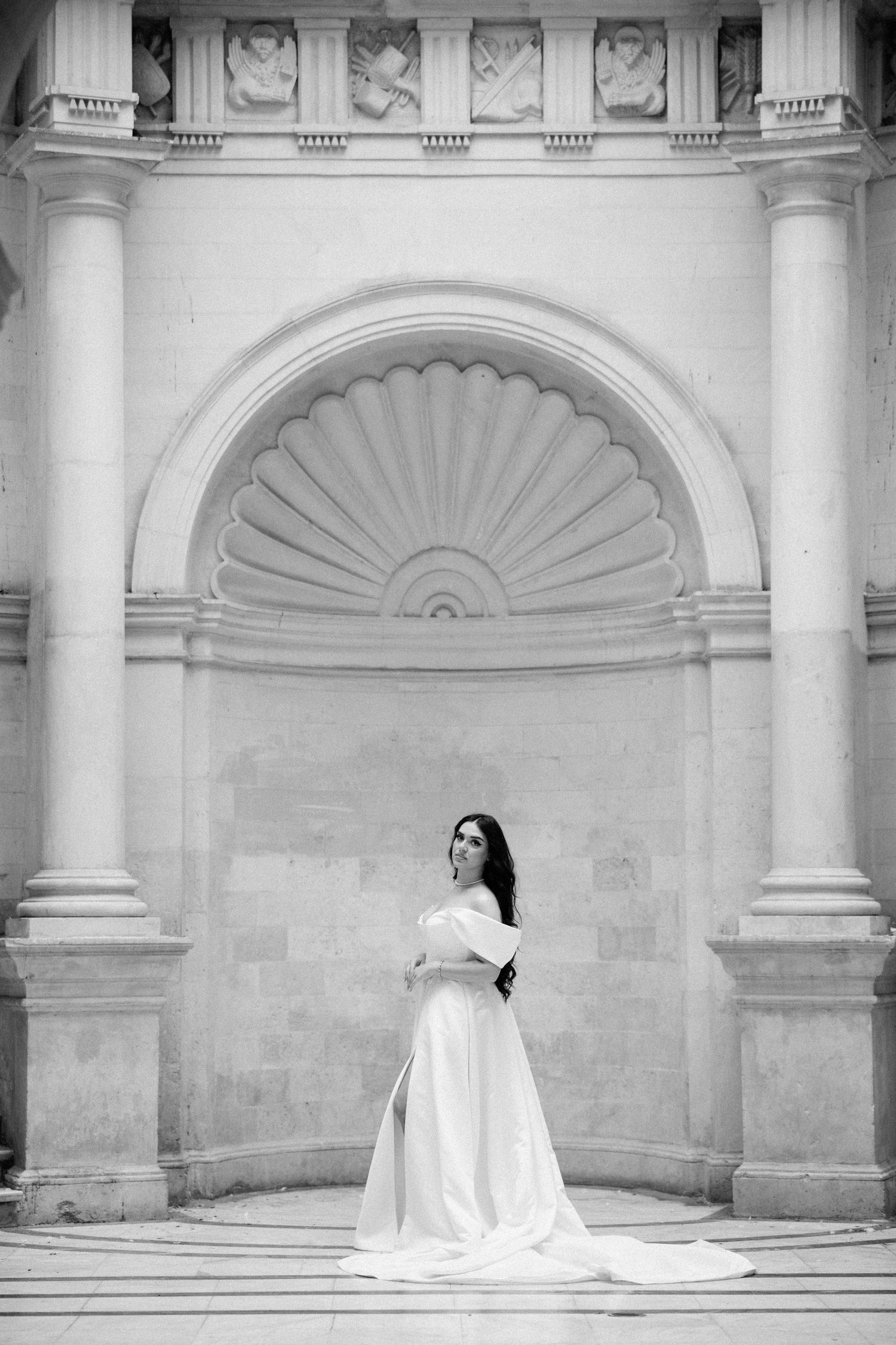 Dramatic black and white bridal portraits in classical architectural setting.