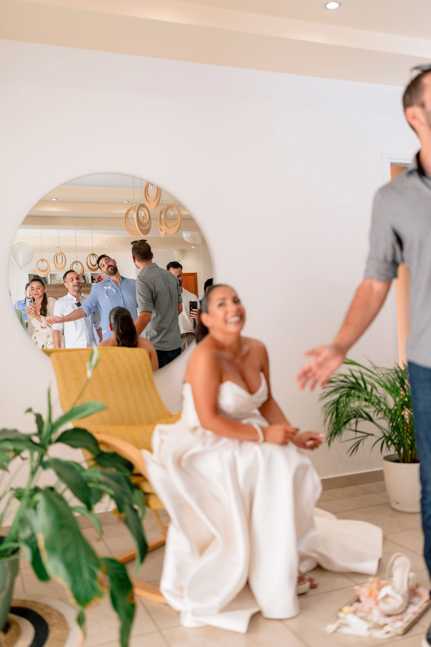 Candid moments during wedding preparation in a bright indoor space.