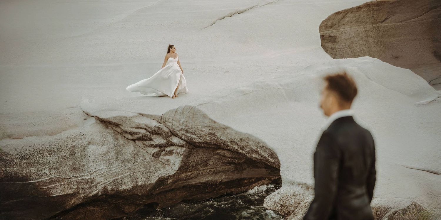 Wedding photography session on dramatic coastal cliffs at sunset.