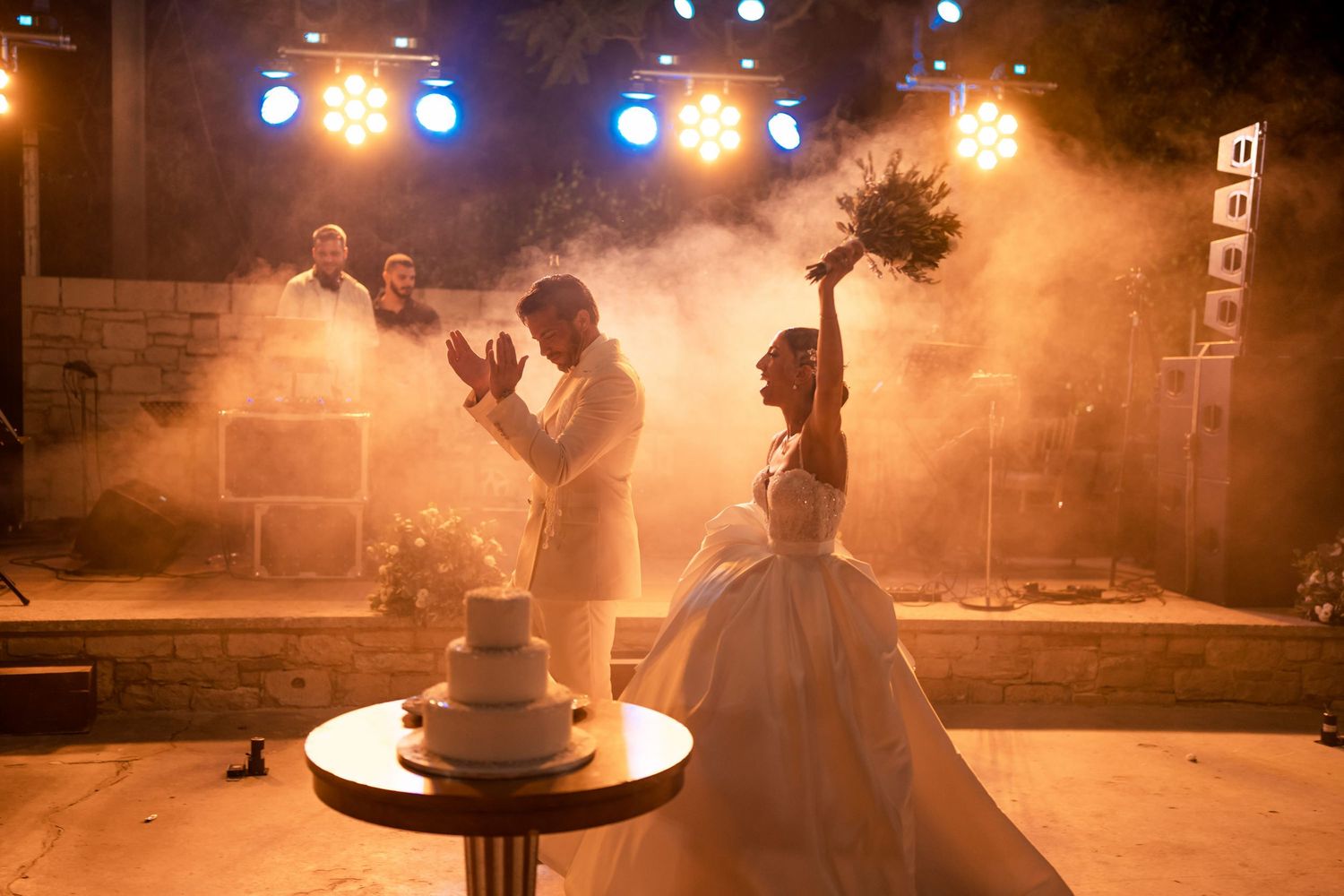 Atmospheric wedding reception scene with orange lighting and fog effects.